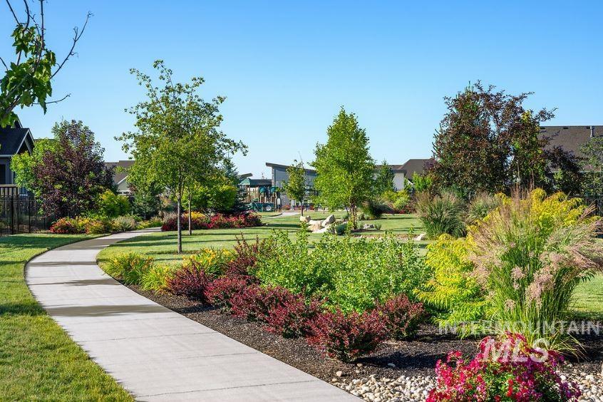 View of home's community with a lawn