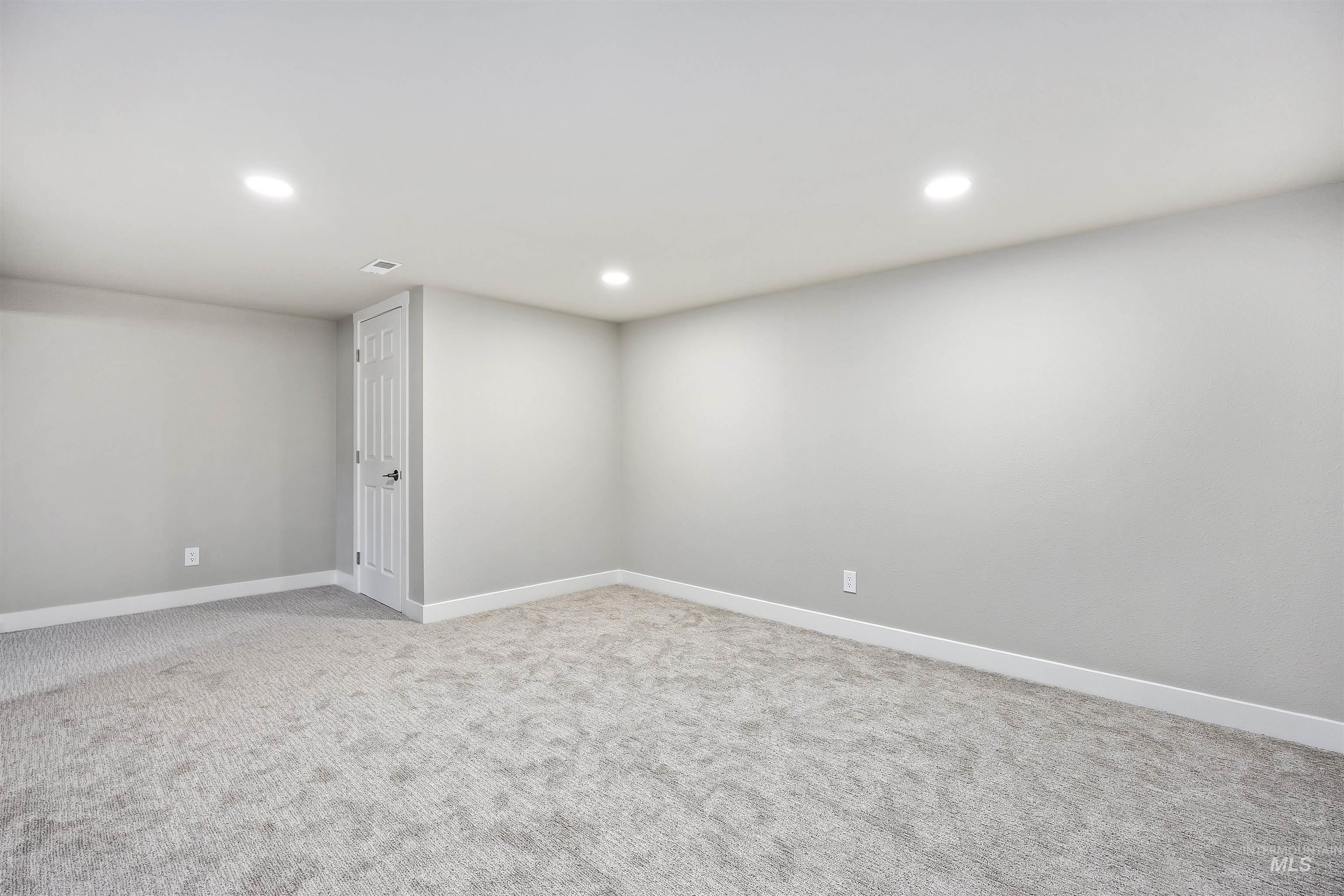 Below grade area featuring light colored carpet and recessed lighting
