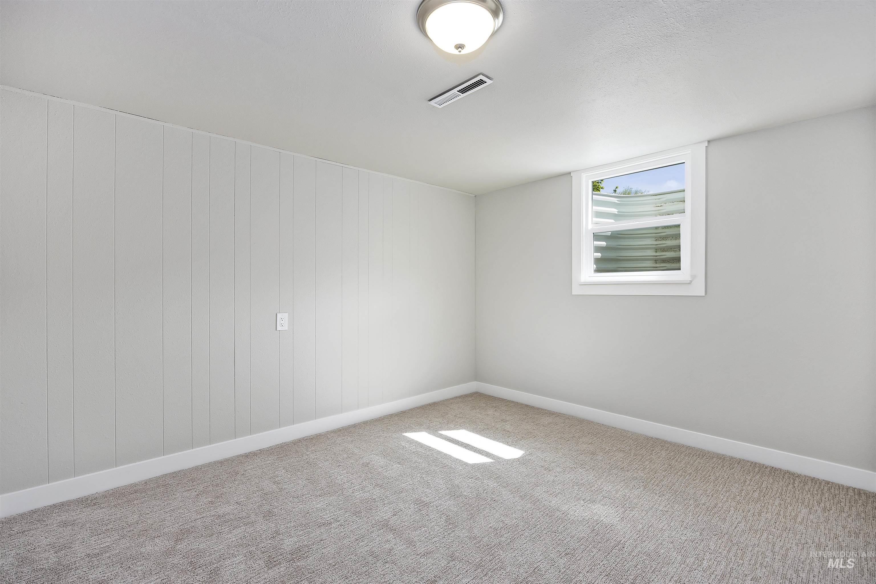 Unfurnished room with carpet and baseboards