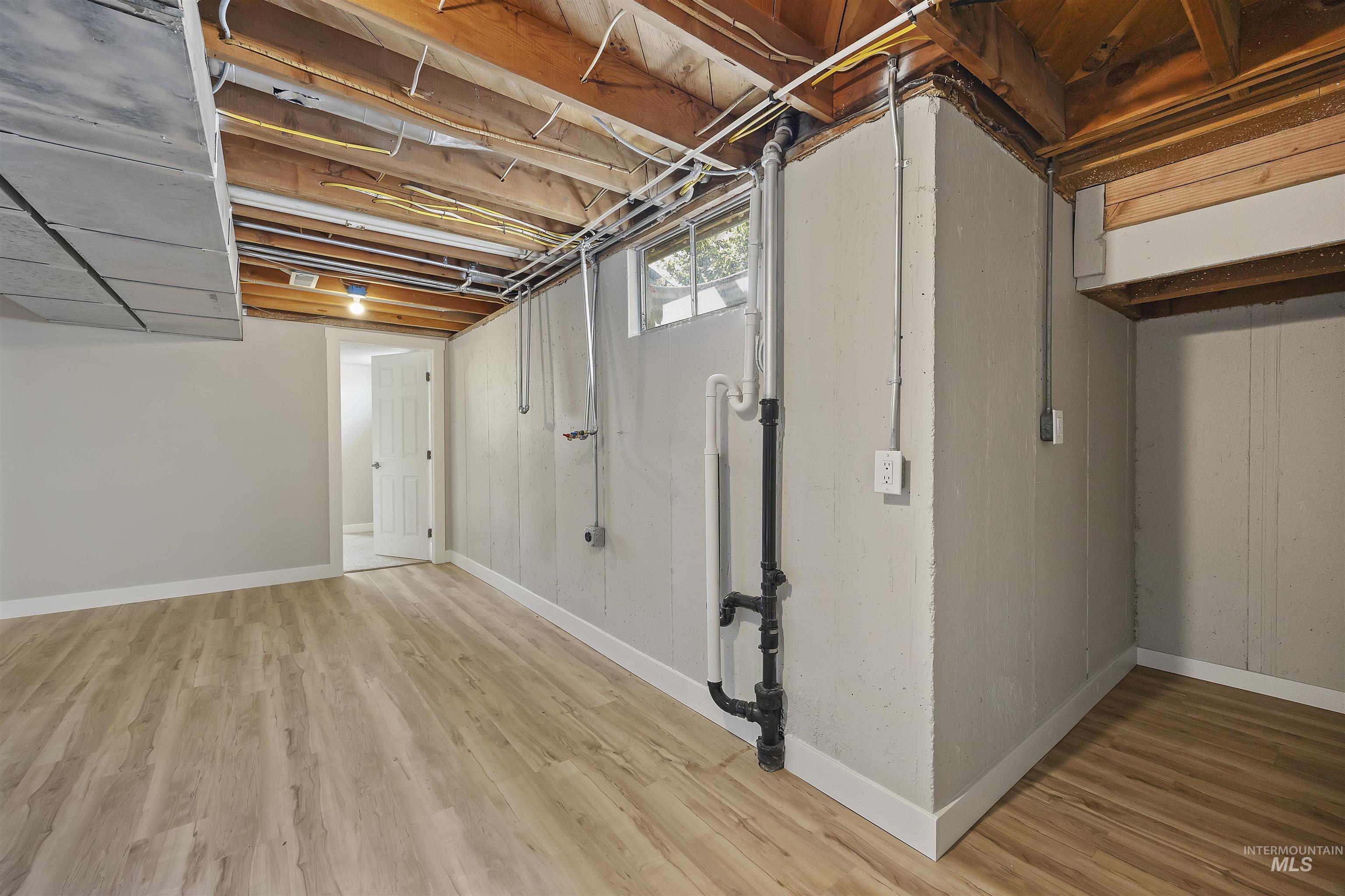 Basement with light wood finished floors