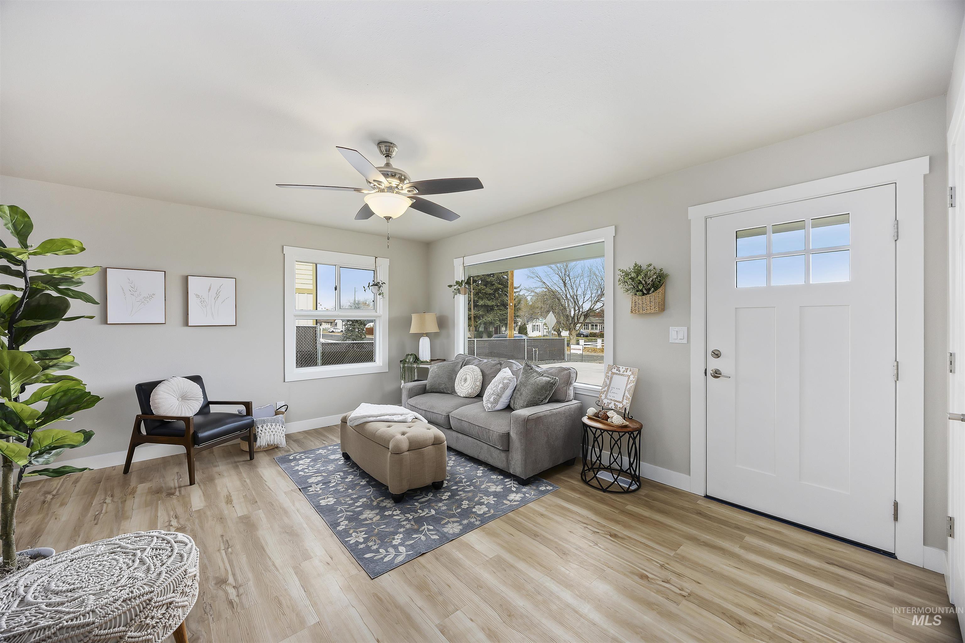 Living room featuring light wood-style floors and ceiling fan