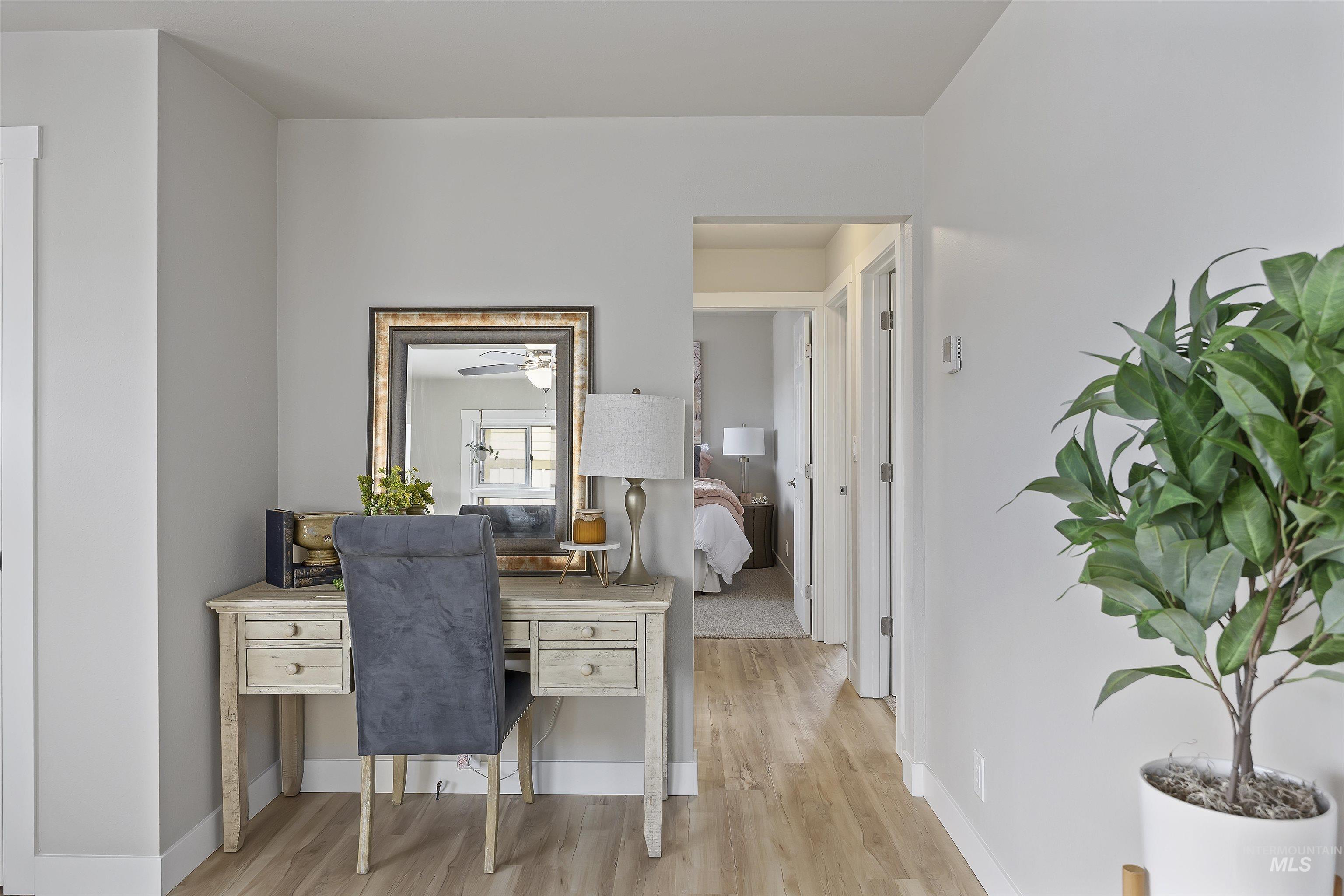 Office area with wood finished floors and baseboards
