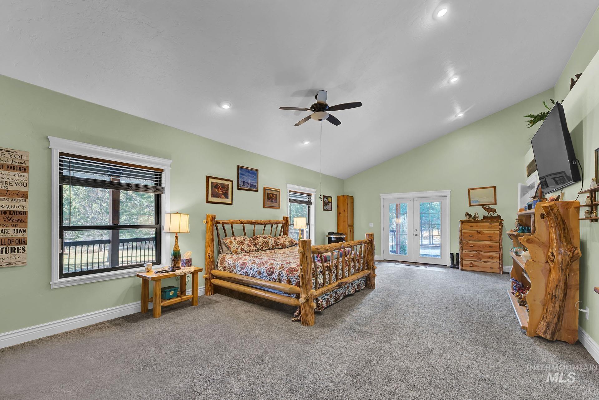 Primary Suite with plenty of natural light - vaulted ceilings - walk in closet - French Doors to side covered walk way