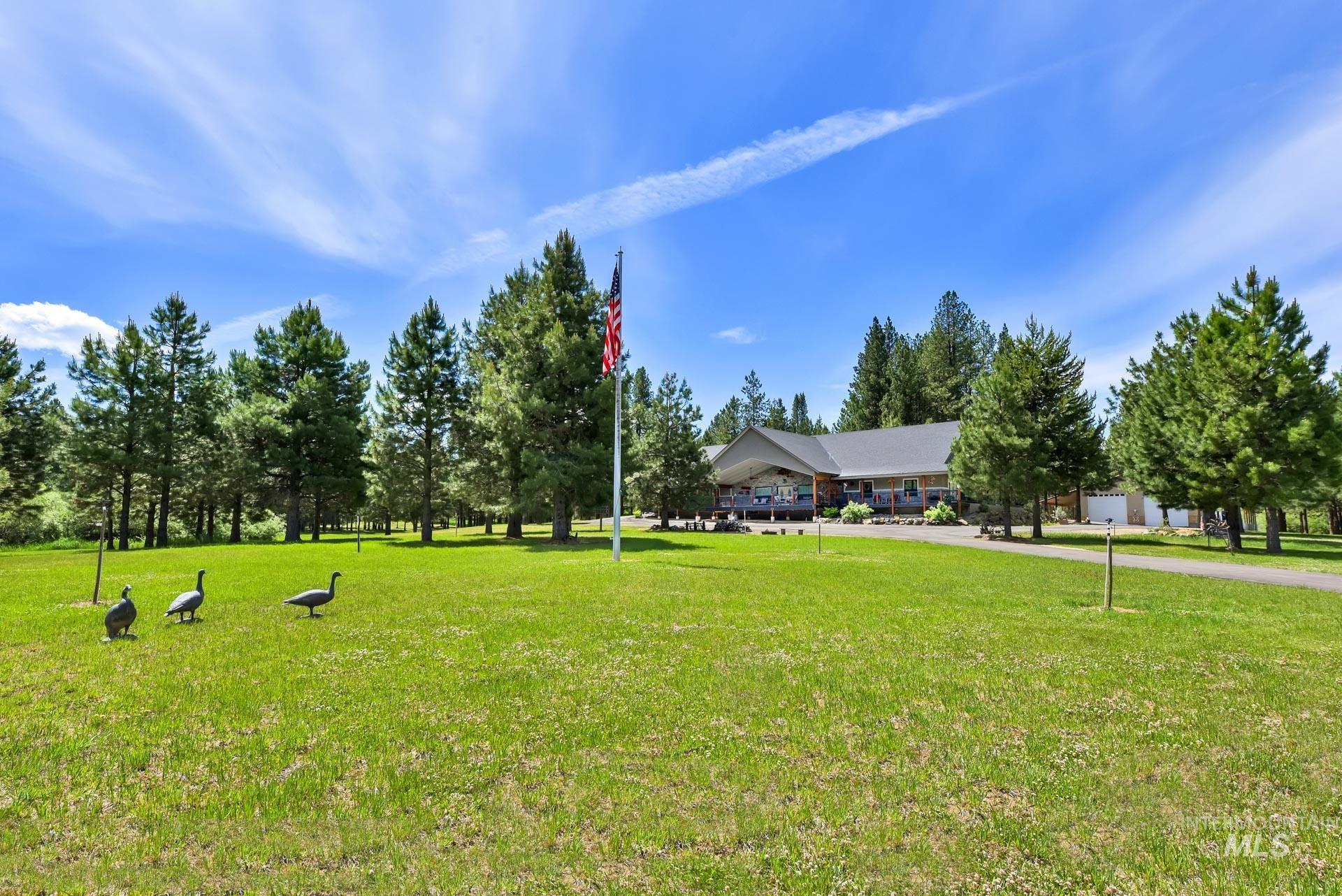 View of front lawn and acreage between road and home
