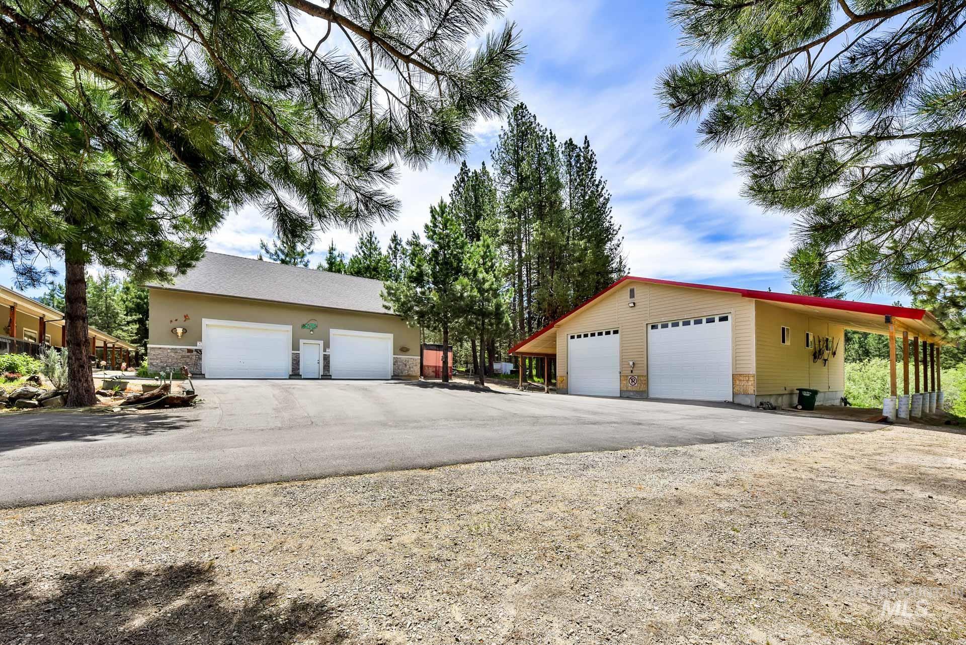 Over sized Two Car Garage with living quarters above the Garage and a detached shop with side wings for covered storage