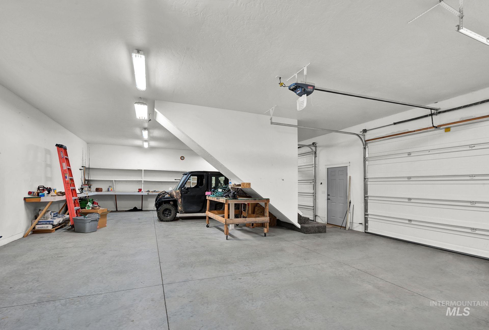 Oversized 2 car garage with upper bedrooms -concrete flooring - fully insulated and painted interior
