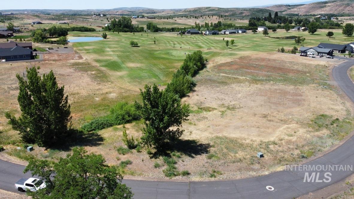 Bird's eye view of a golf course and a water and mountain view