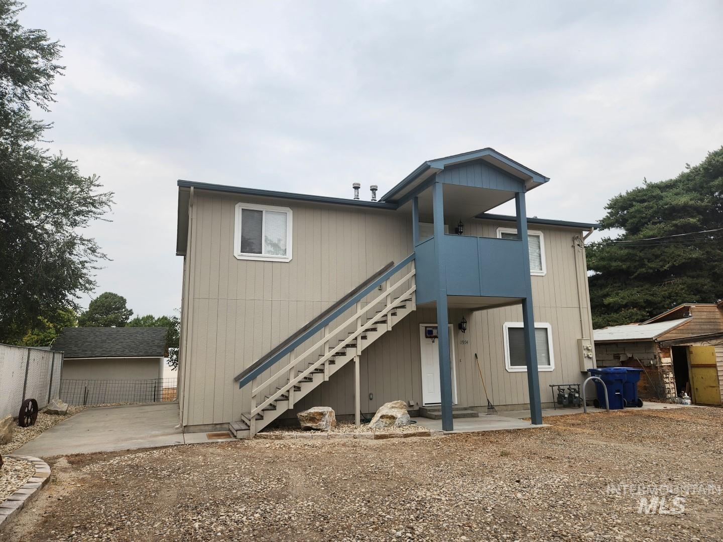 Rear view of property with stairs, a patio area, and a wooden deck