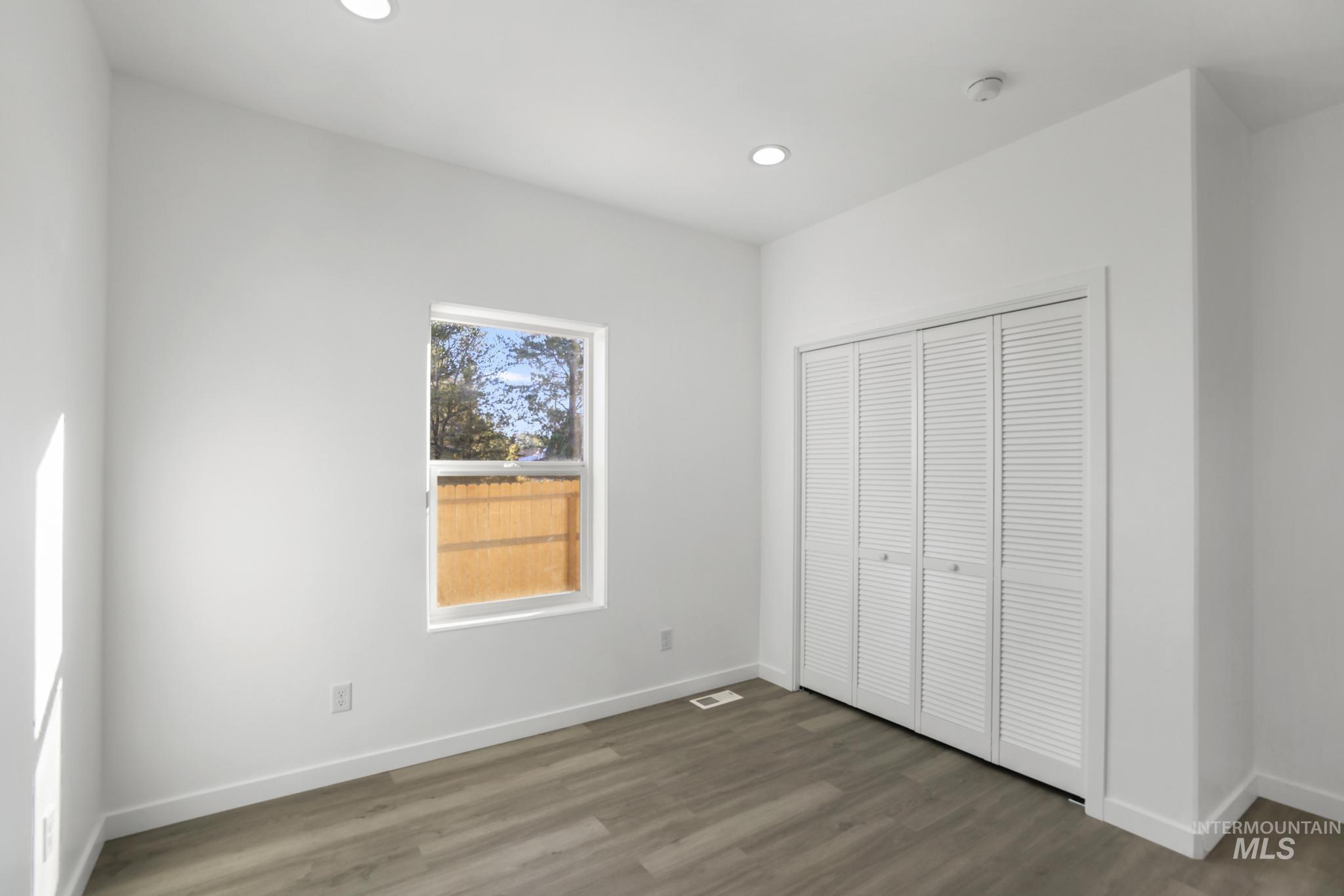 Unfurnished bedroom featuring recessed lighting, wood finished floors, and a closet