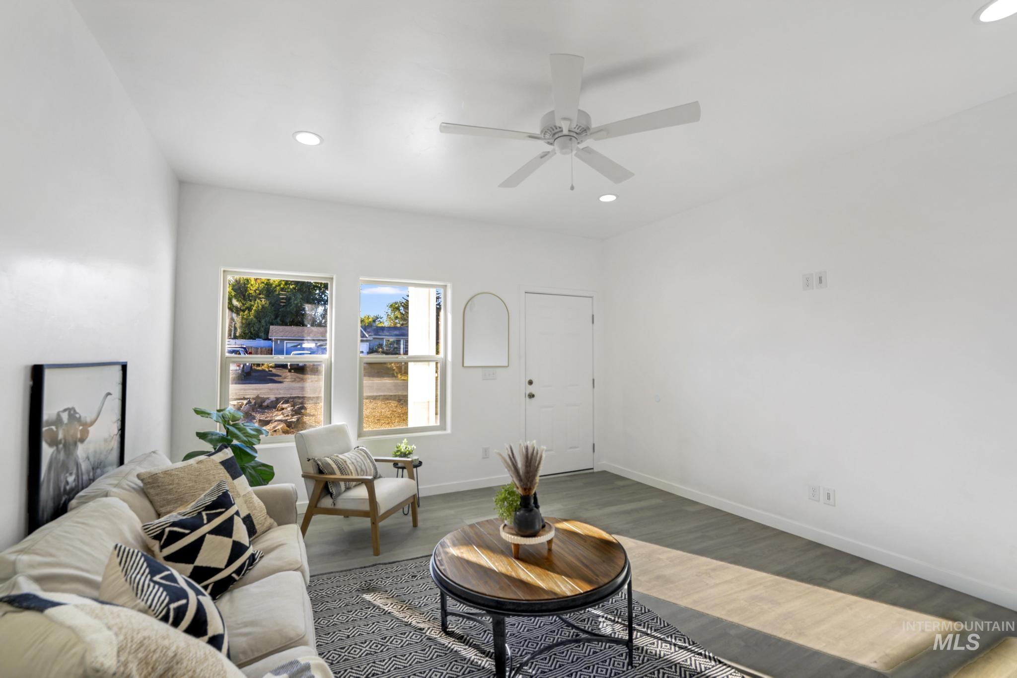 Living room featuring wood finished floors, recessed lighting, and a ceiling fan