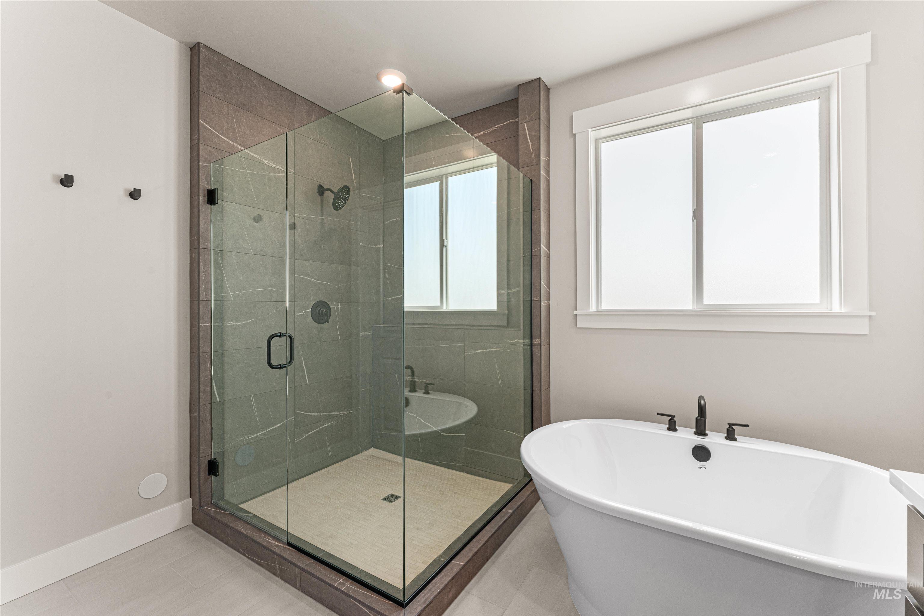 Full bathroom with a soaking tub and a shower stall