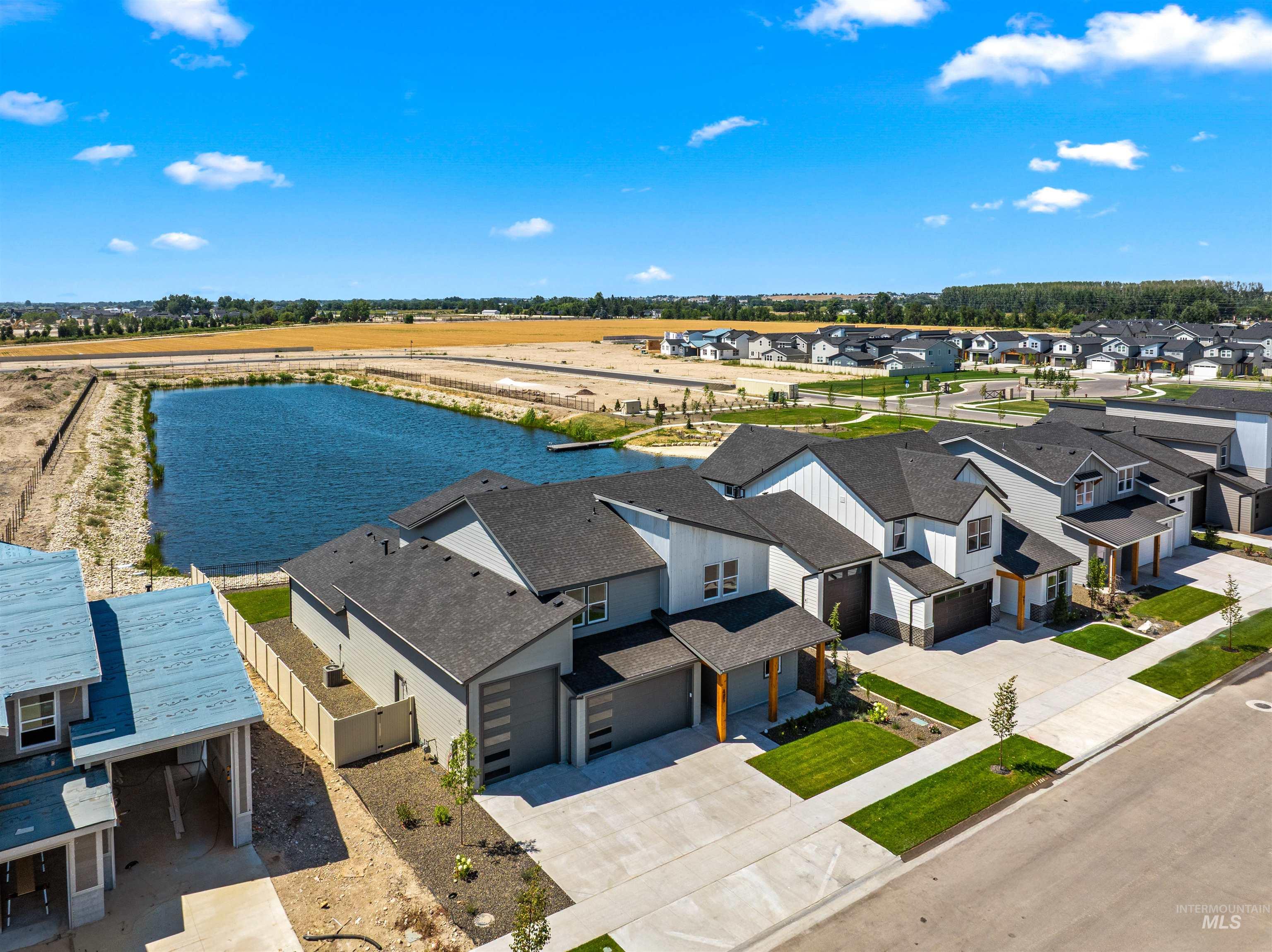Aerial perspective of suburban area featuring a nearby body of water