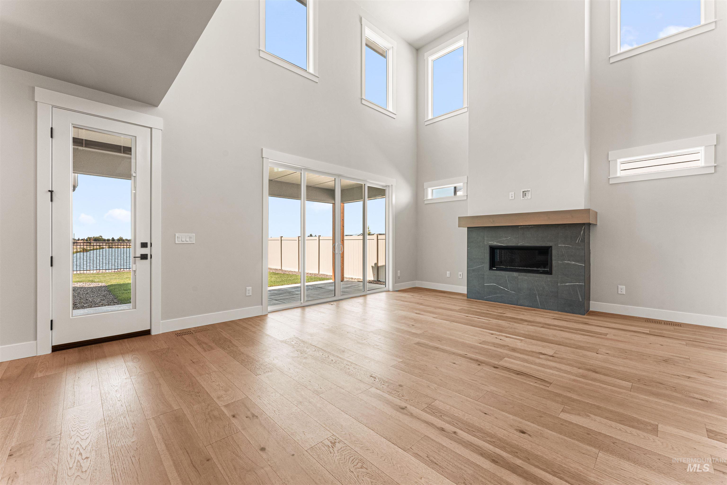 Unfurnished living room featuring a fireplace and light wood-style flooring