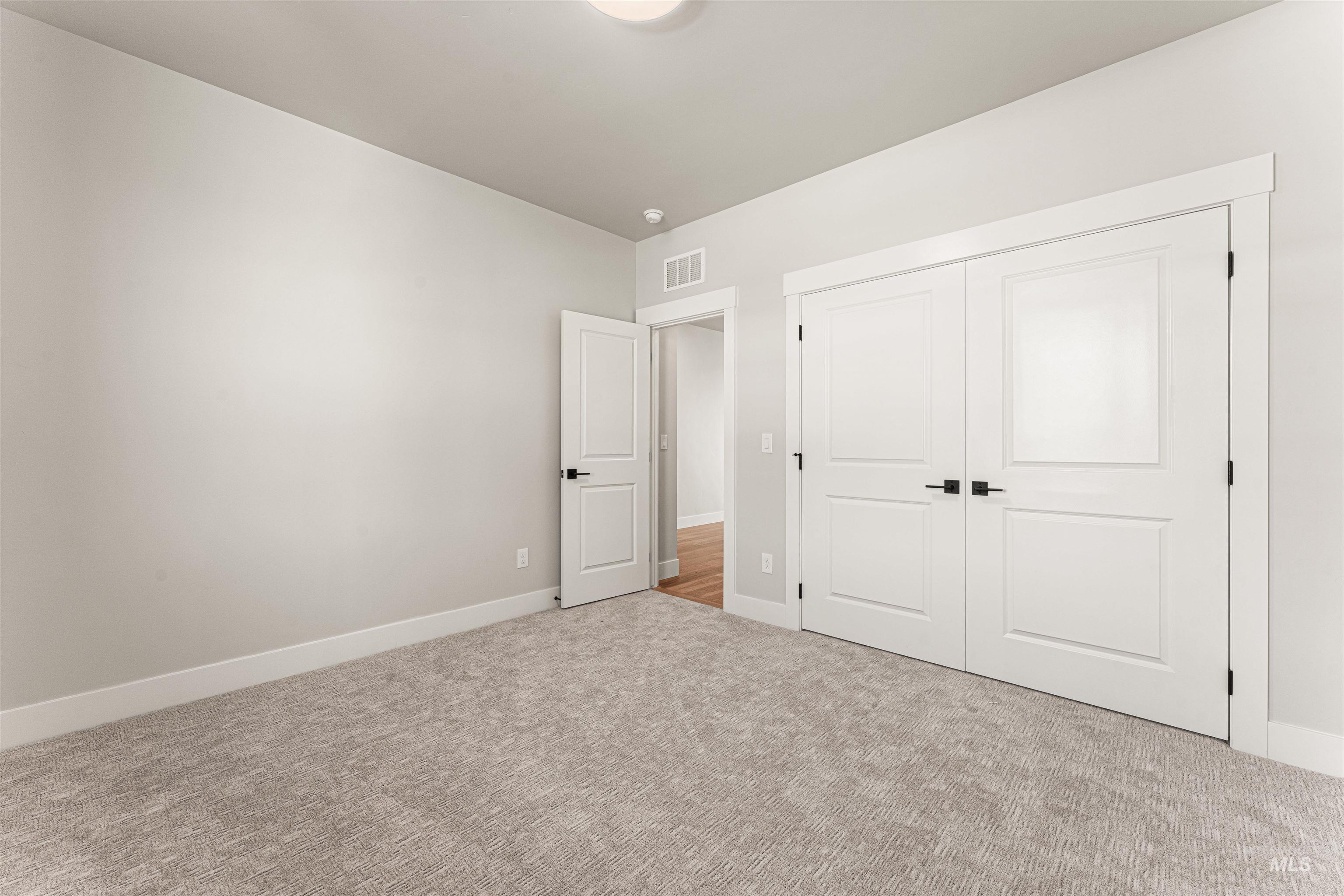 Unfurnished bedroom featuring carpet and a closet