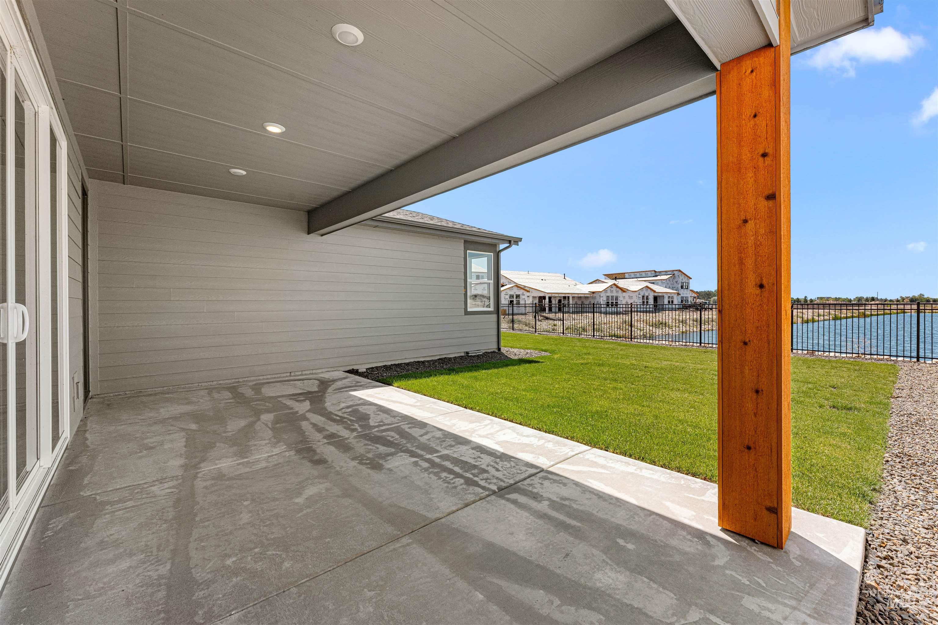 View of patio with a water view and a carport