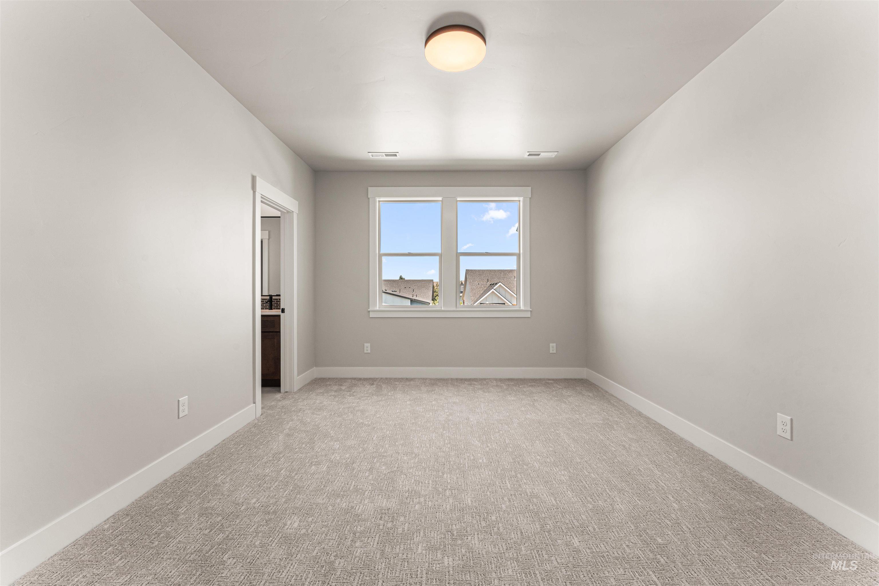Empty room featuring carpet floors and baseboards