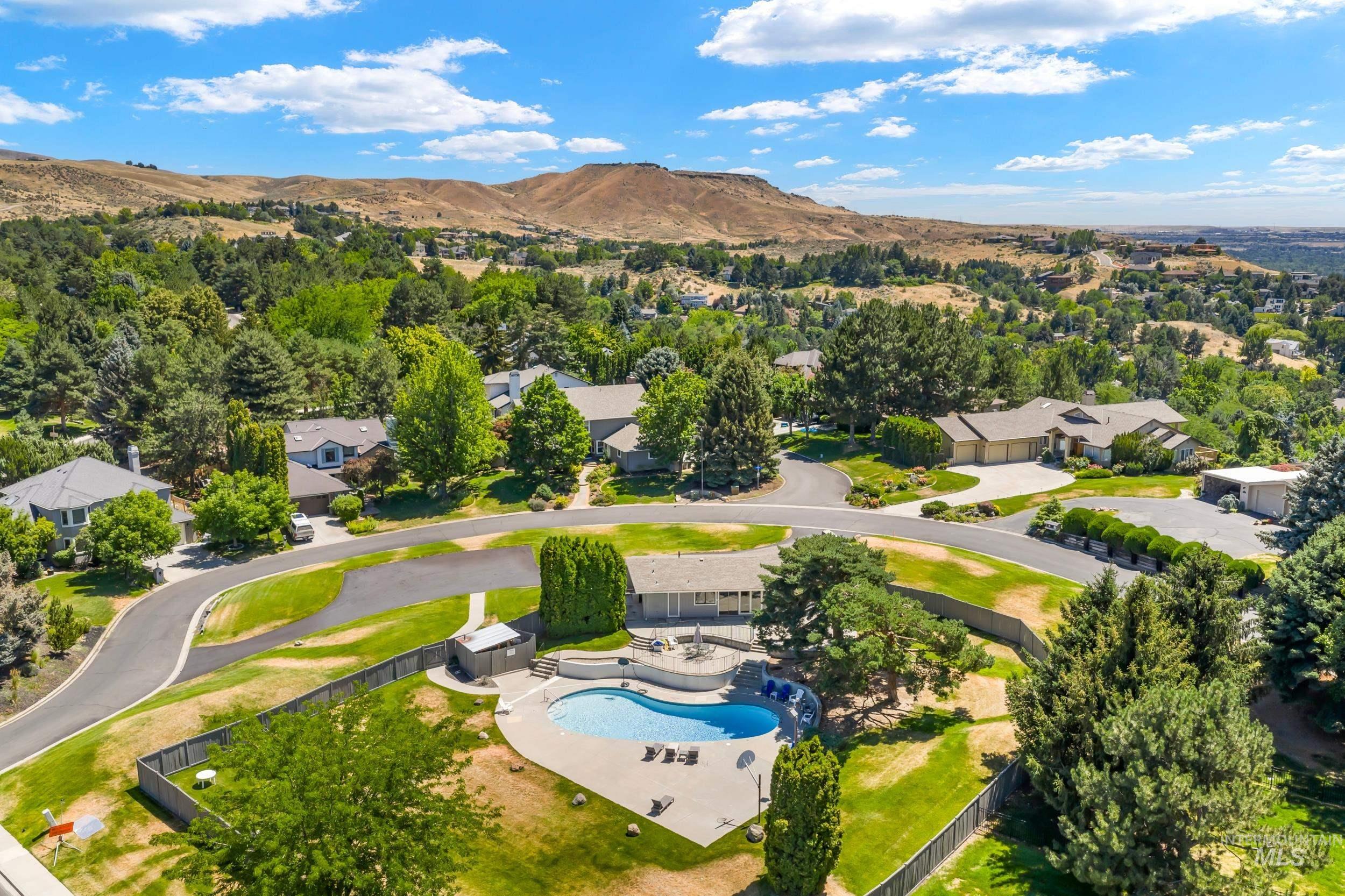 Drone / aerial view of a pool and a mountainous background