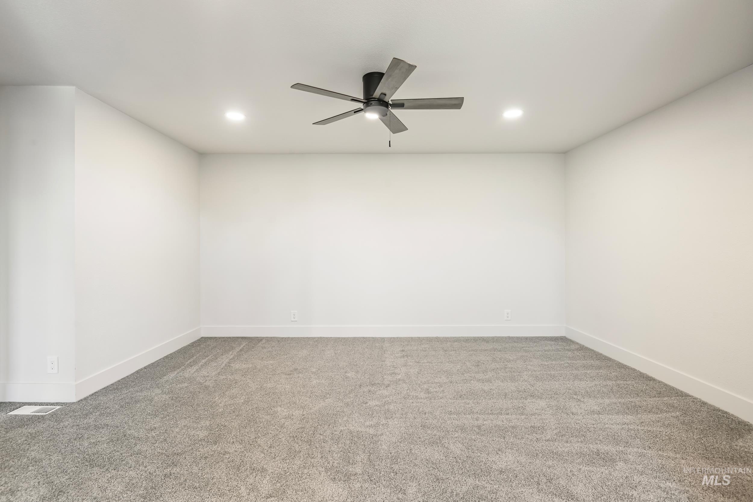 Empty room with light carpet, recessed lighting, and ceiling fan