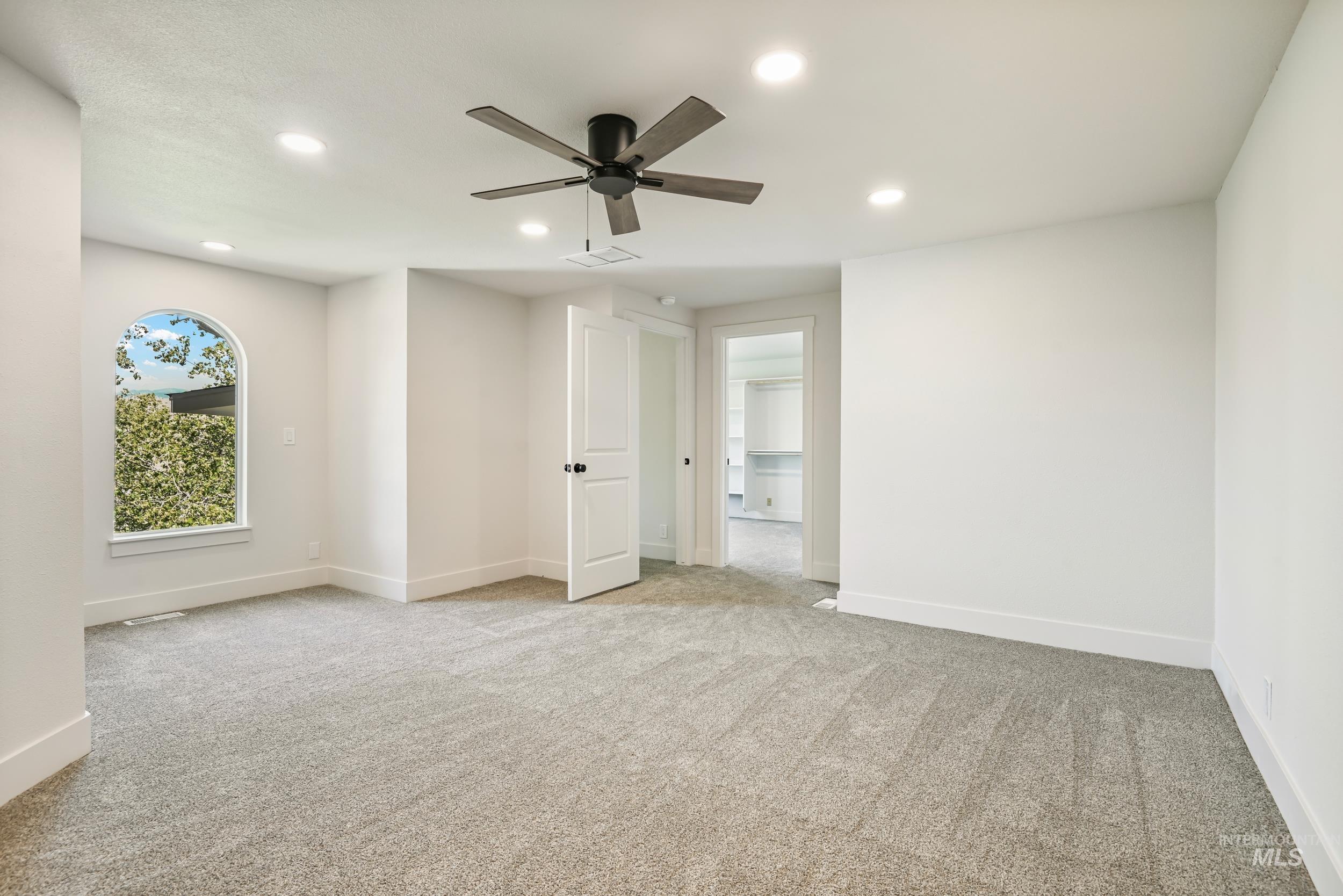 Unfurnished room with light carpet, recessed lighting, and a ceiling fan