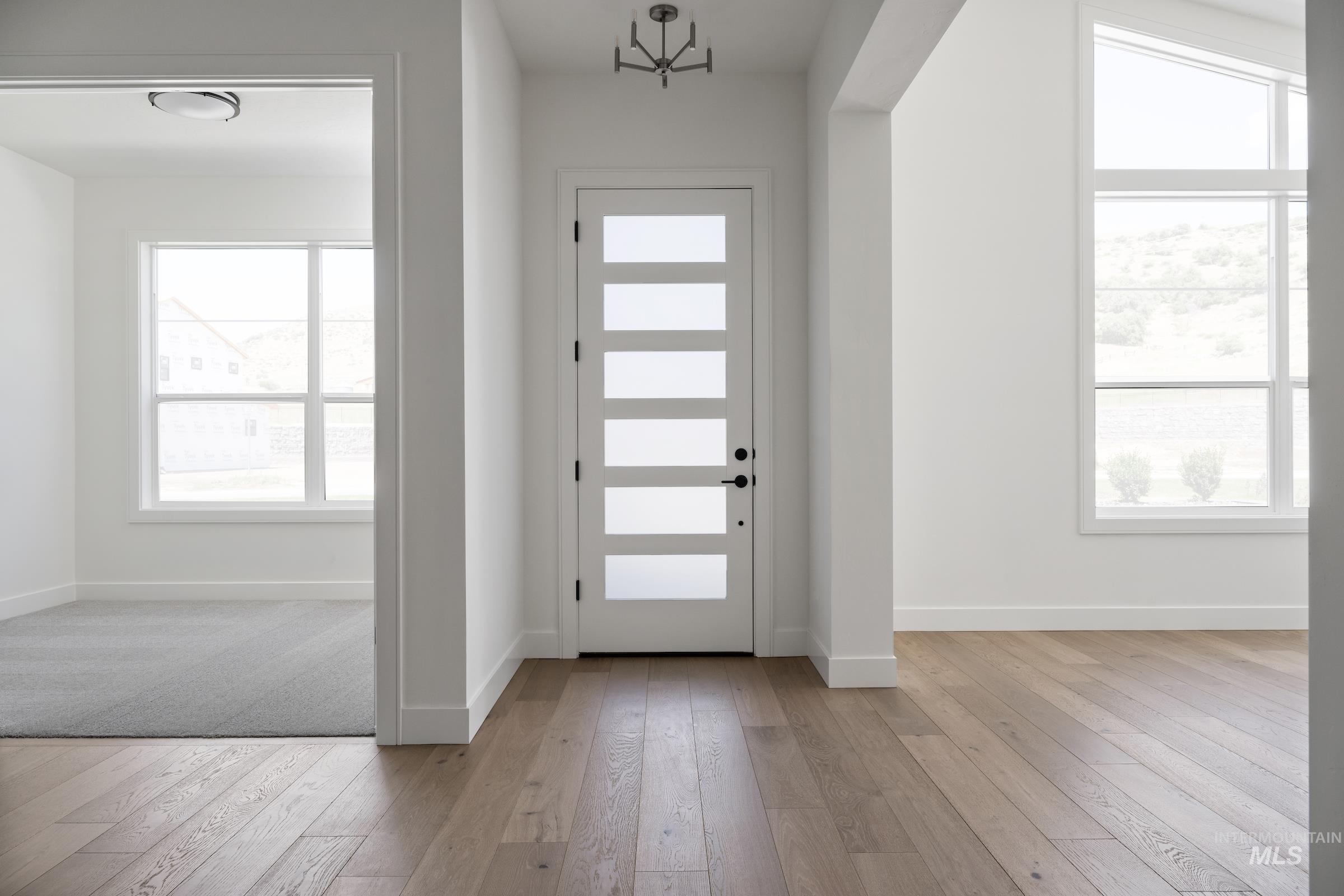 Foyer with baseboards and light wood-style floors