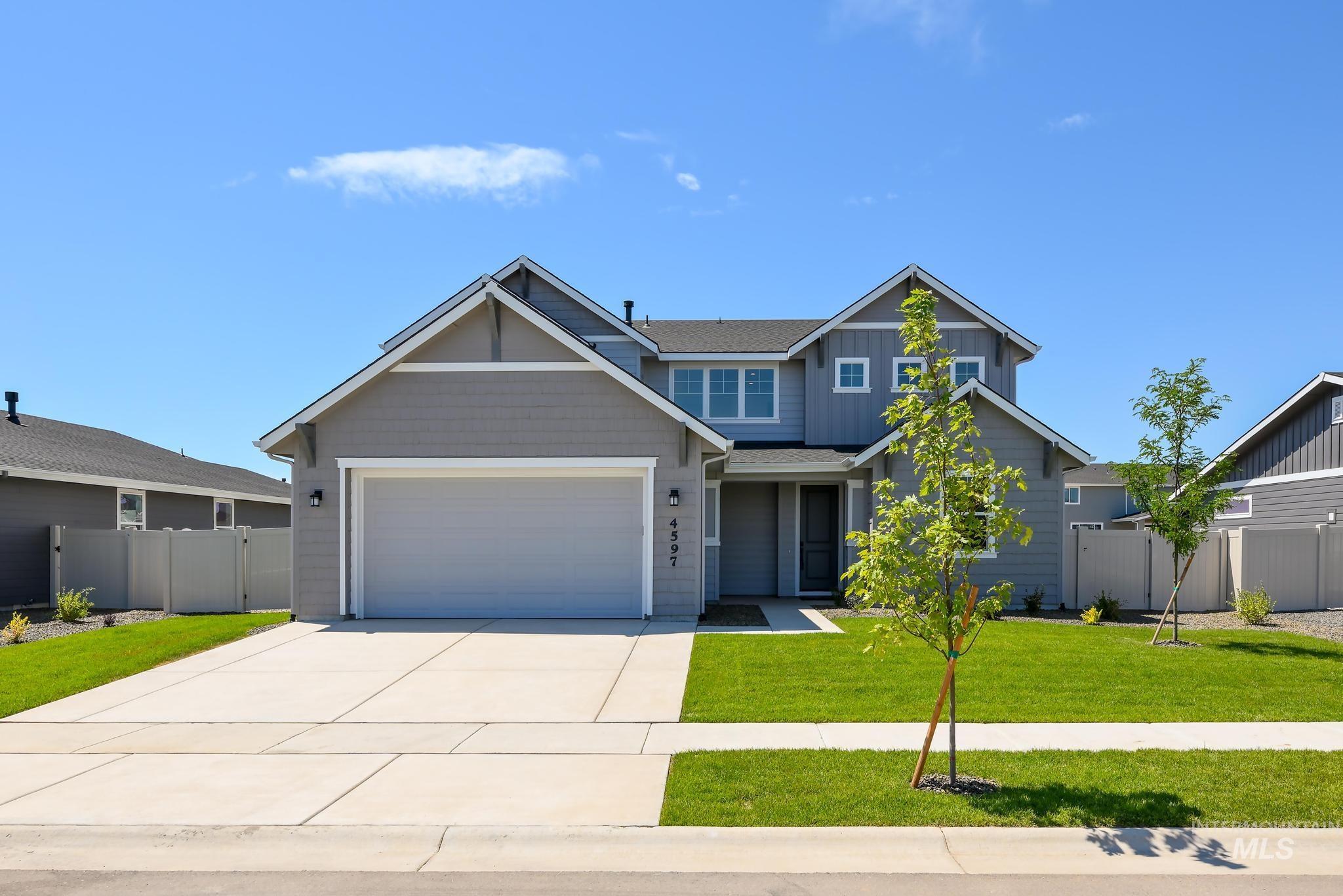Craftsman inspired home featuring driveway and an attached garage