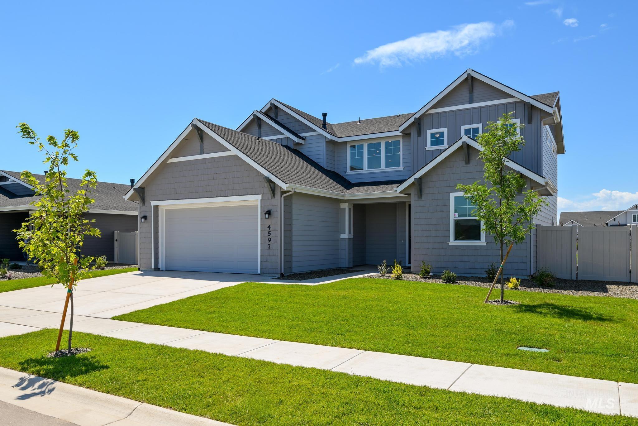 Craftsman house with concrete driveway, a garage, roof with shingles, a gate, and board and batten siding