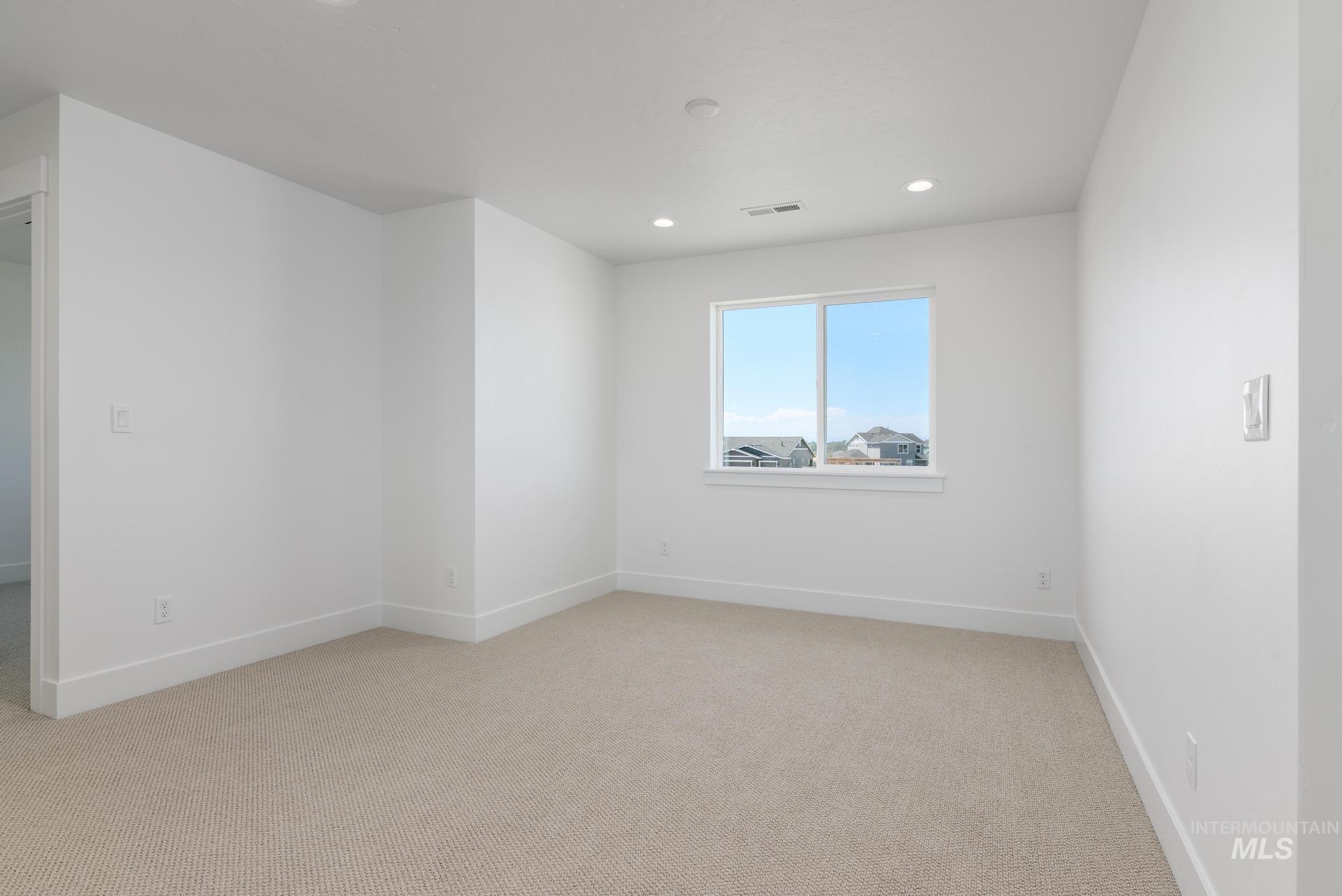 Spare room with light colored carpet and recessed lighting
