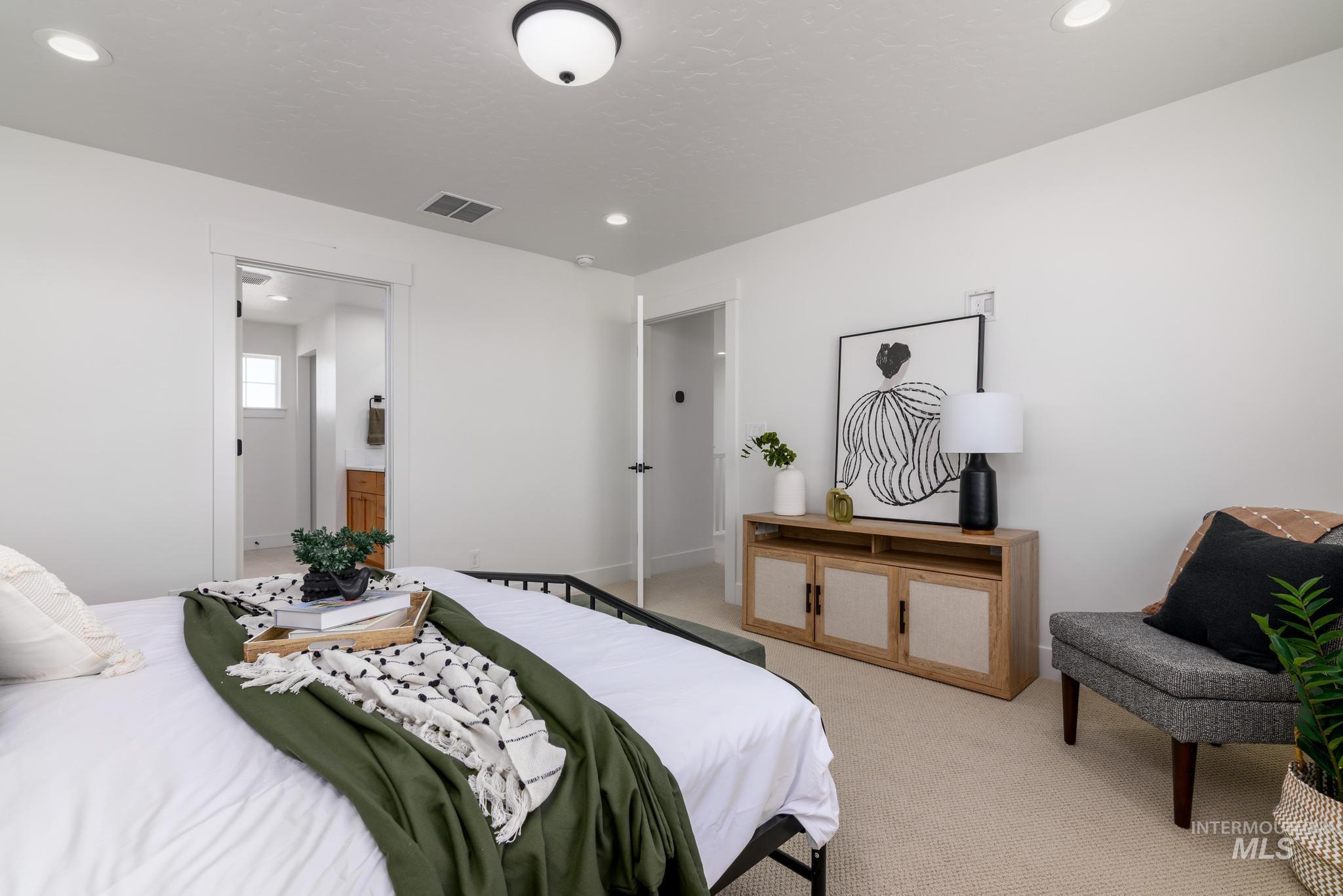 Bedroom with light colored carpet and recessed lighting