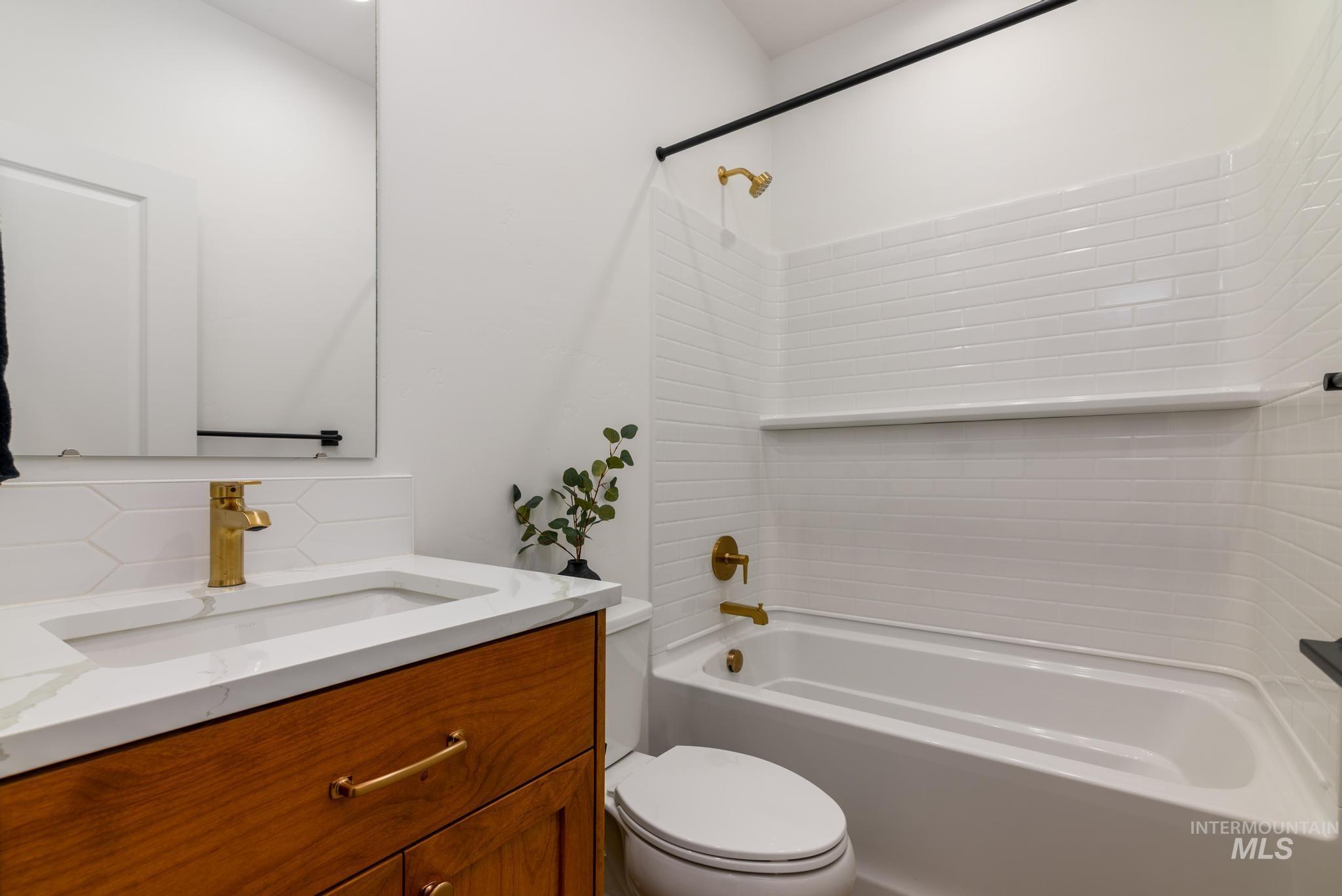Bathroom featuring vanity and shower / tub combination