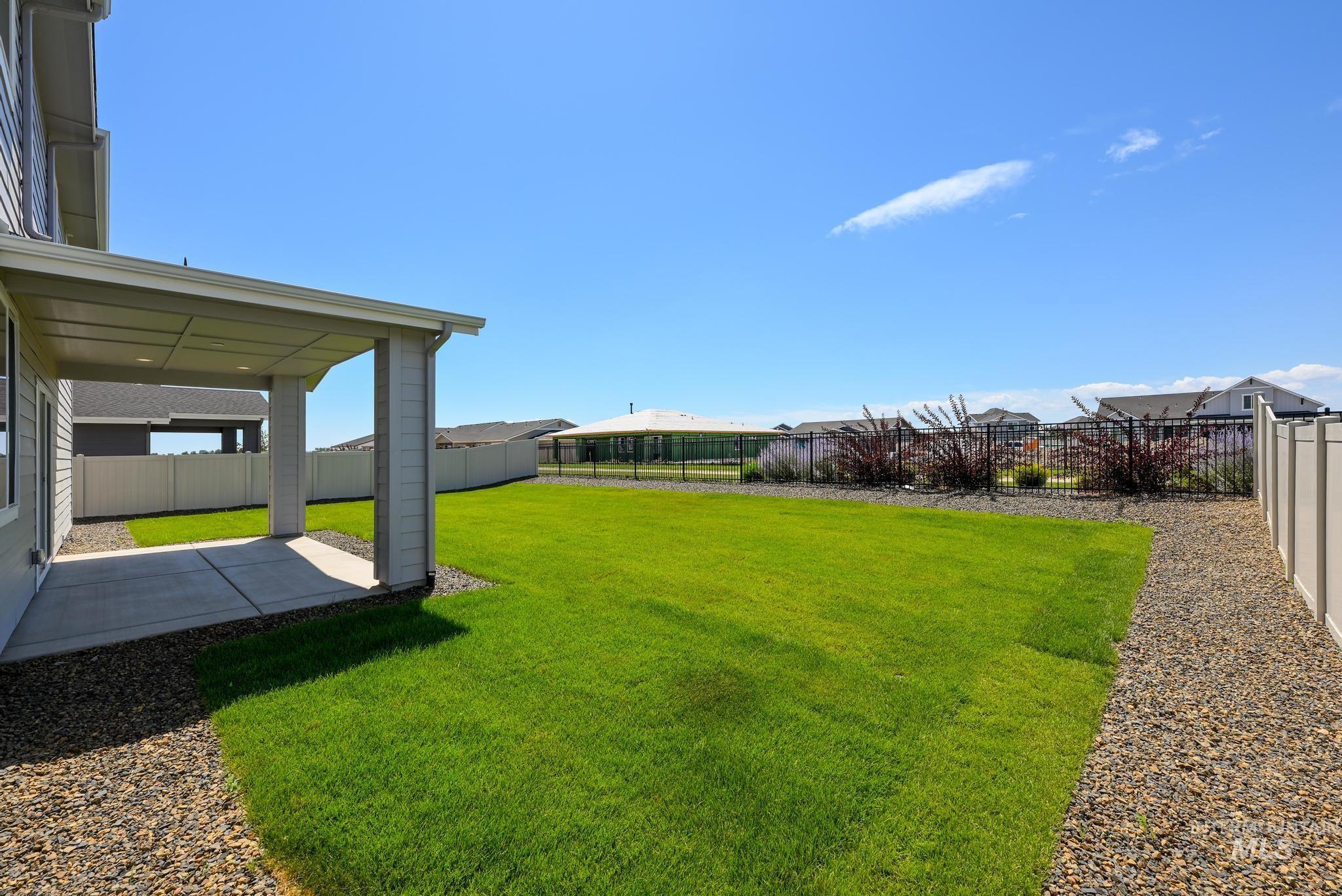 Fenced backyard with a patio area