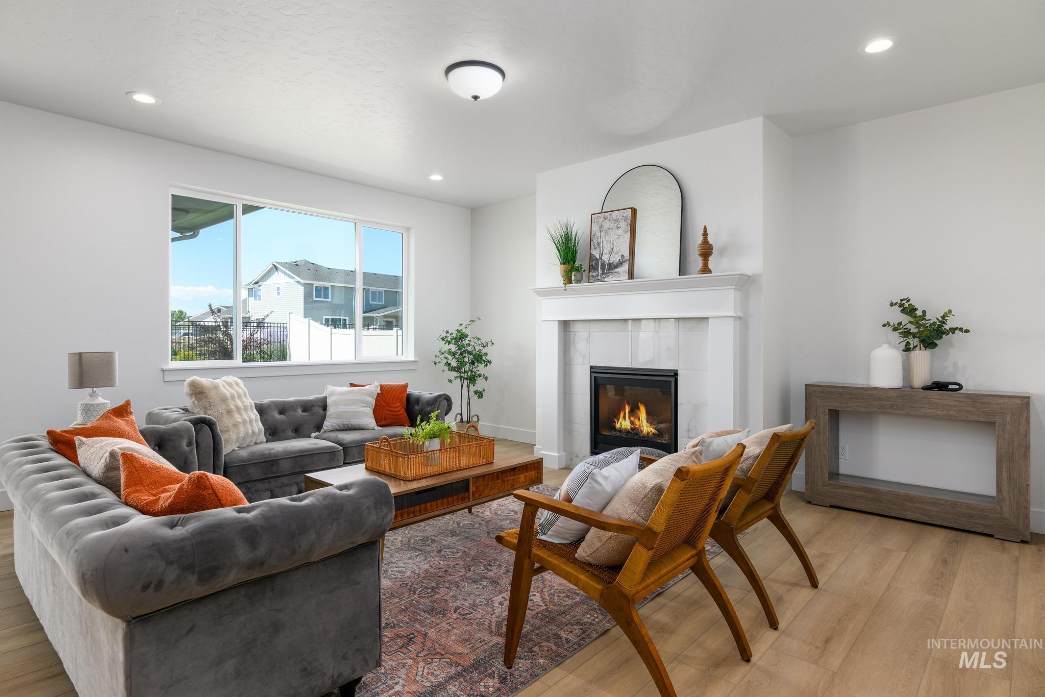 Living area featuring a fireplace, light wood-type flooring, and recessed lighting