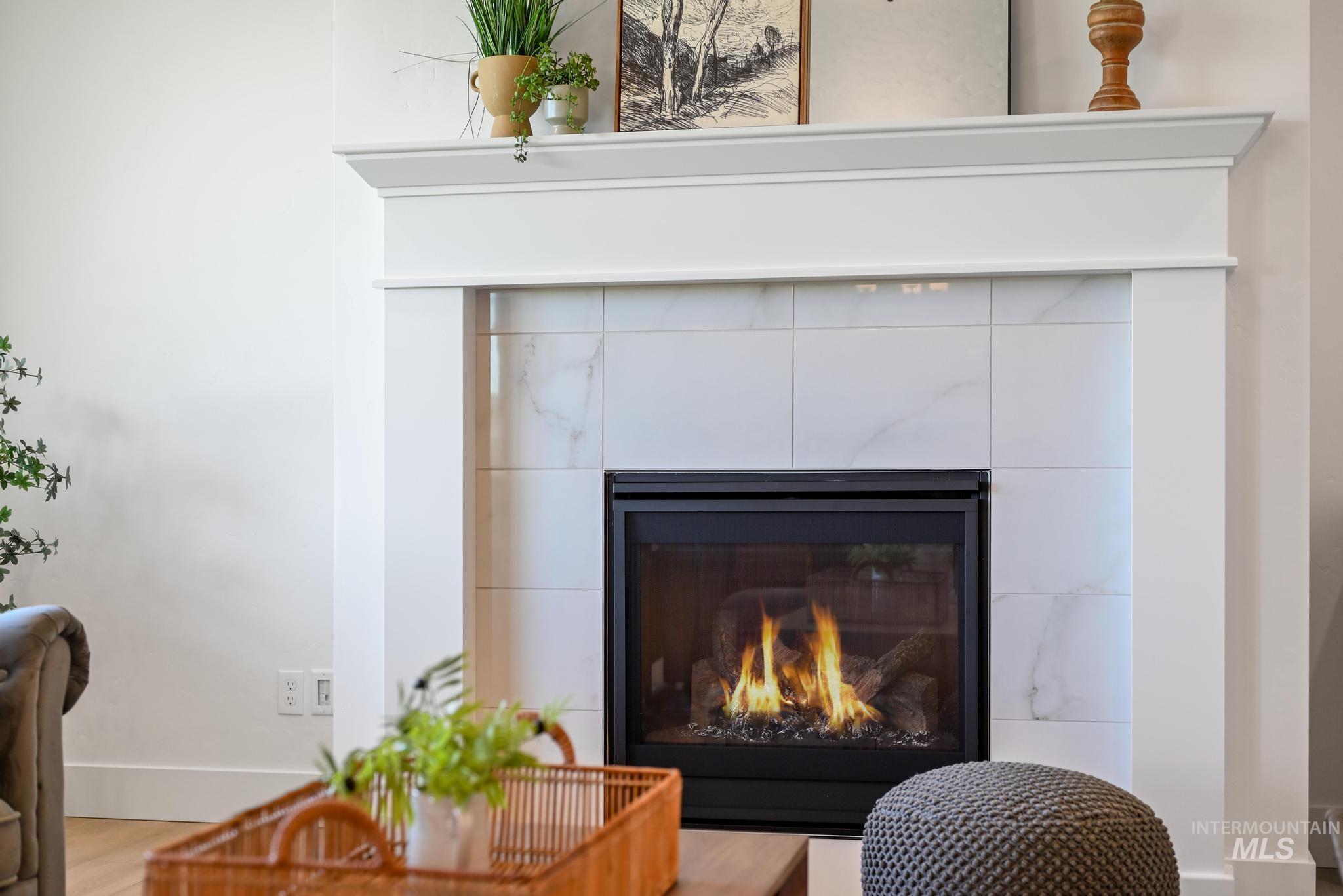 Detailed view of wood finished floors and a tile fireplace