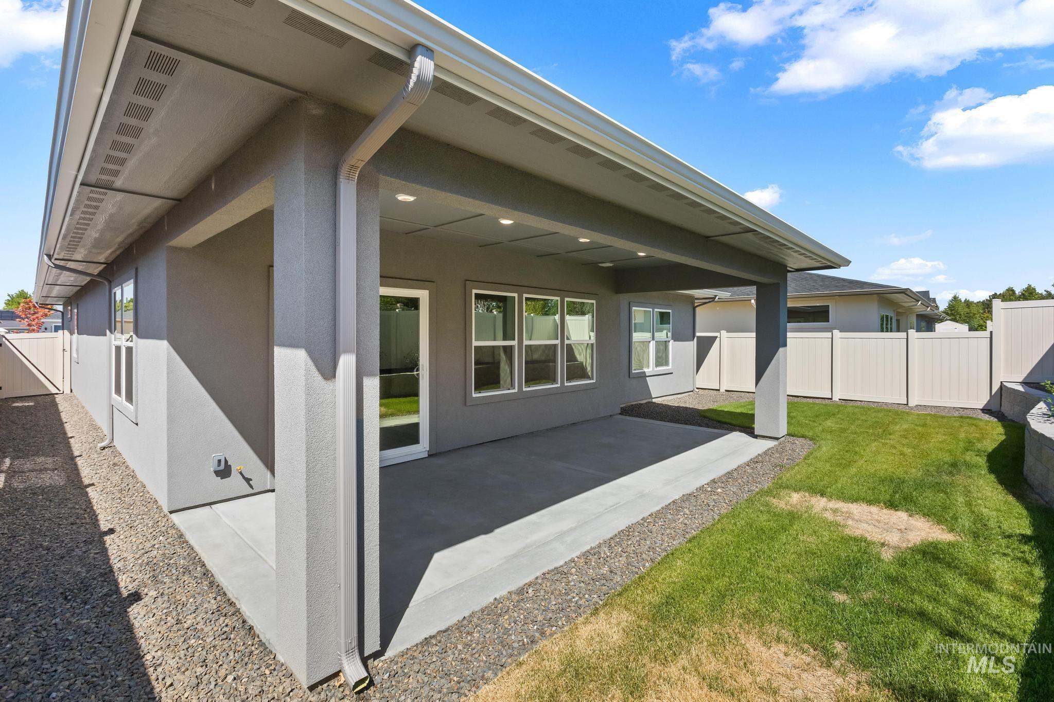 Back of property with a patio, a fenced backyard, and stucco siding