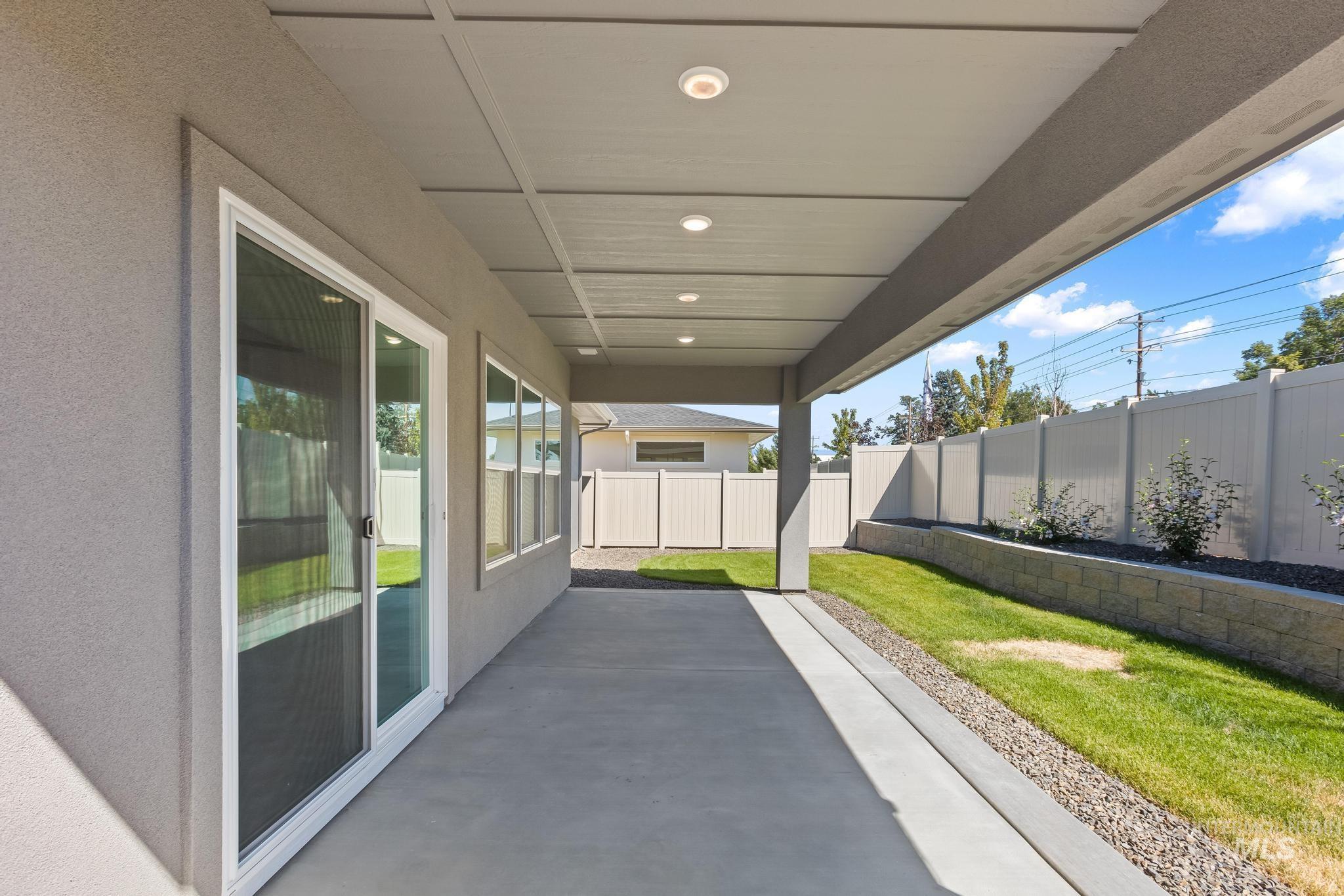 Fenced backyard with a patio