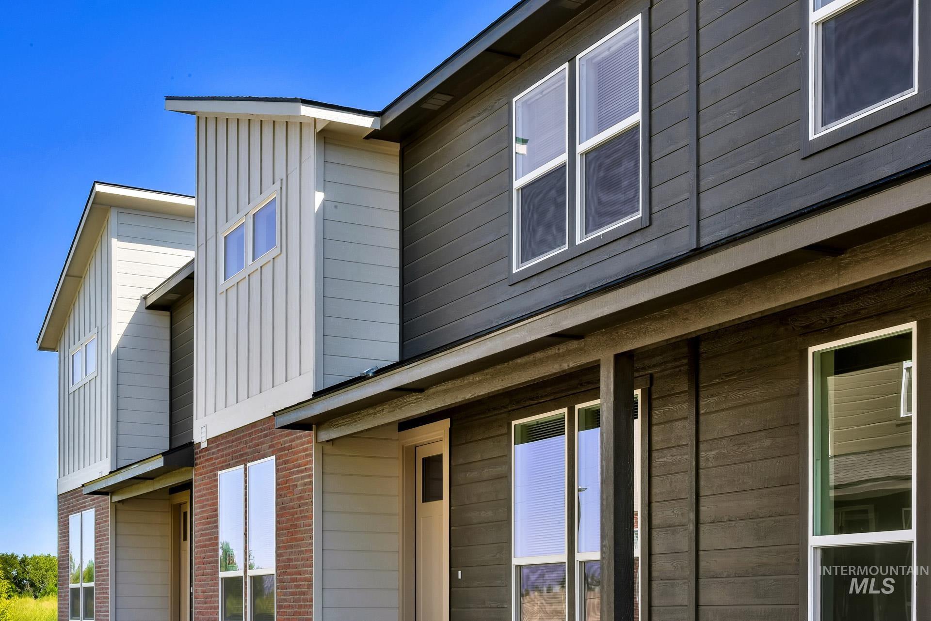 View of home's exterior with board and batten siding and brick siding