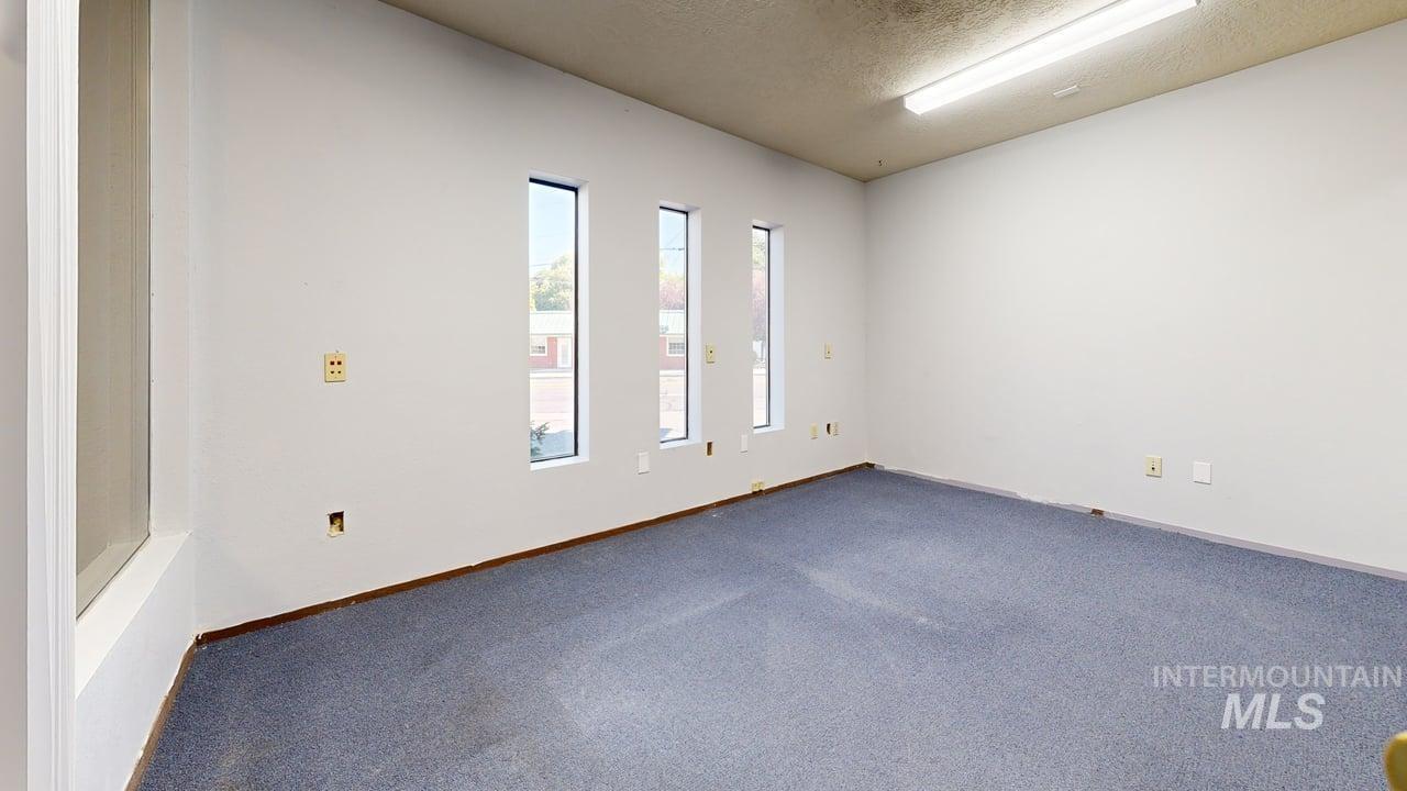 Unfurnished room with a textured ceiling and carpet floors