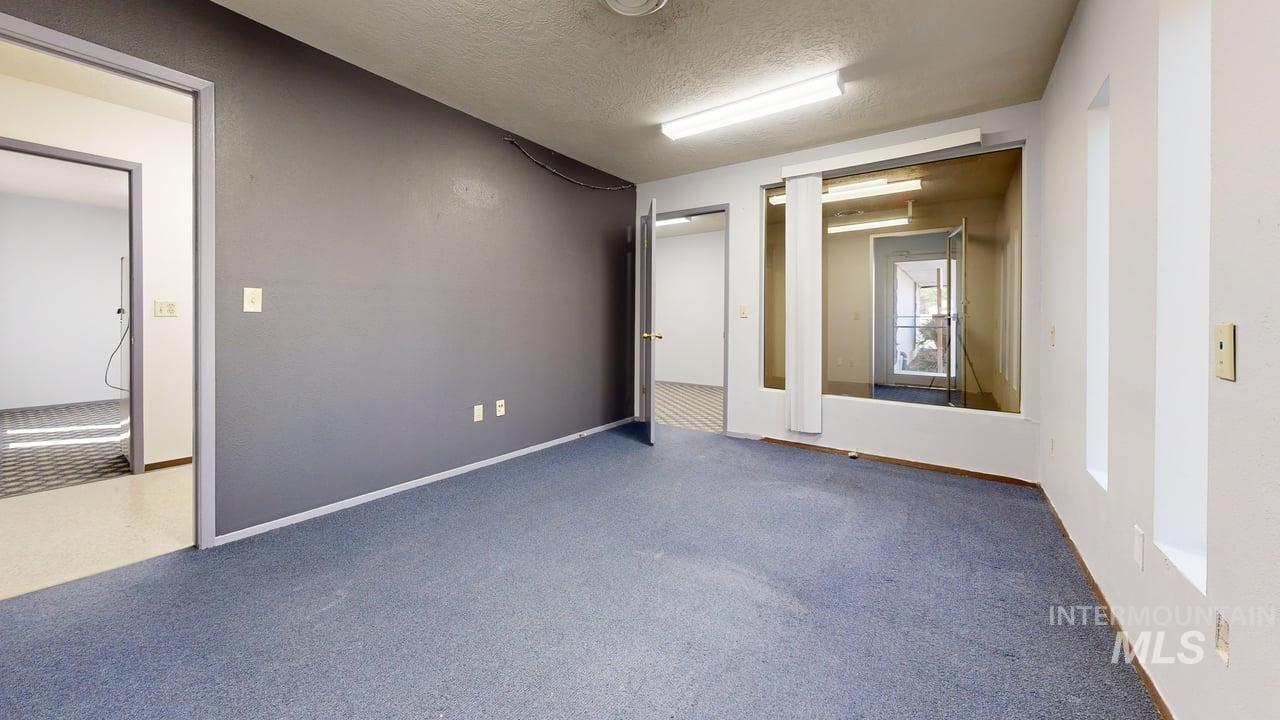 Spare room with a textured ceiling and carpet