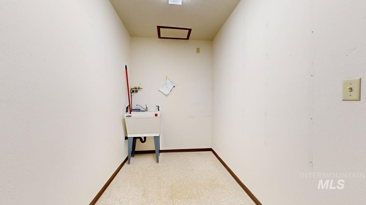Laundry area featuring washer hookup and light carpet