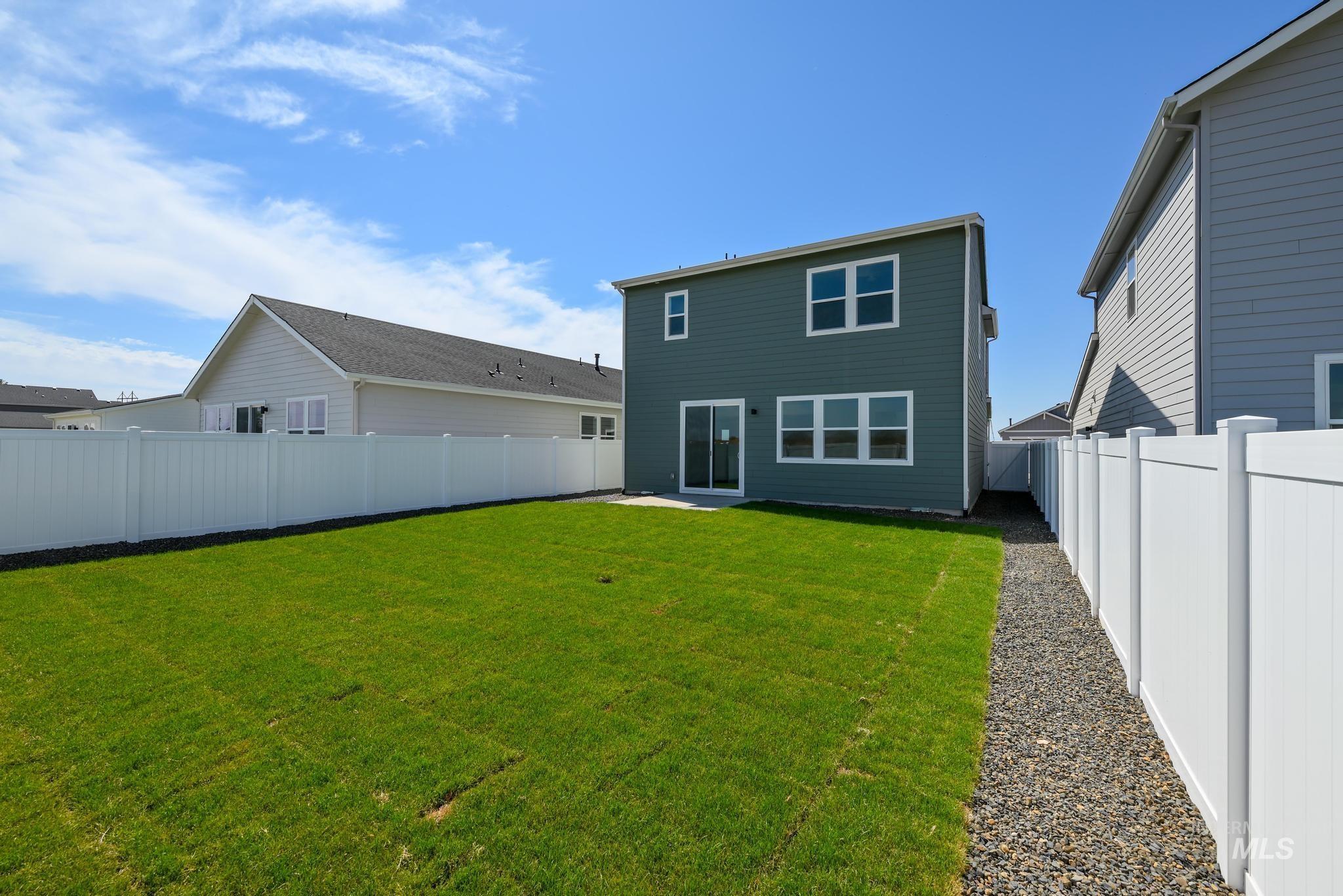 Back of property featuring a fenced backyard