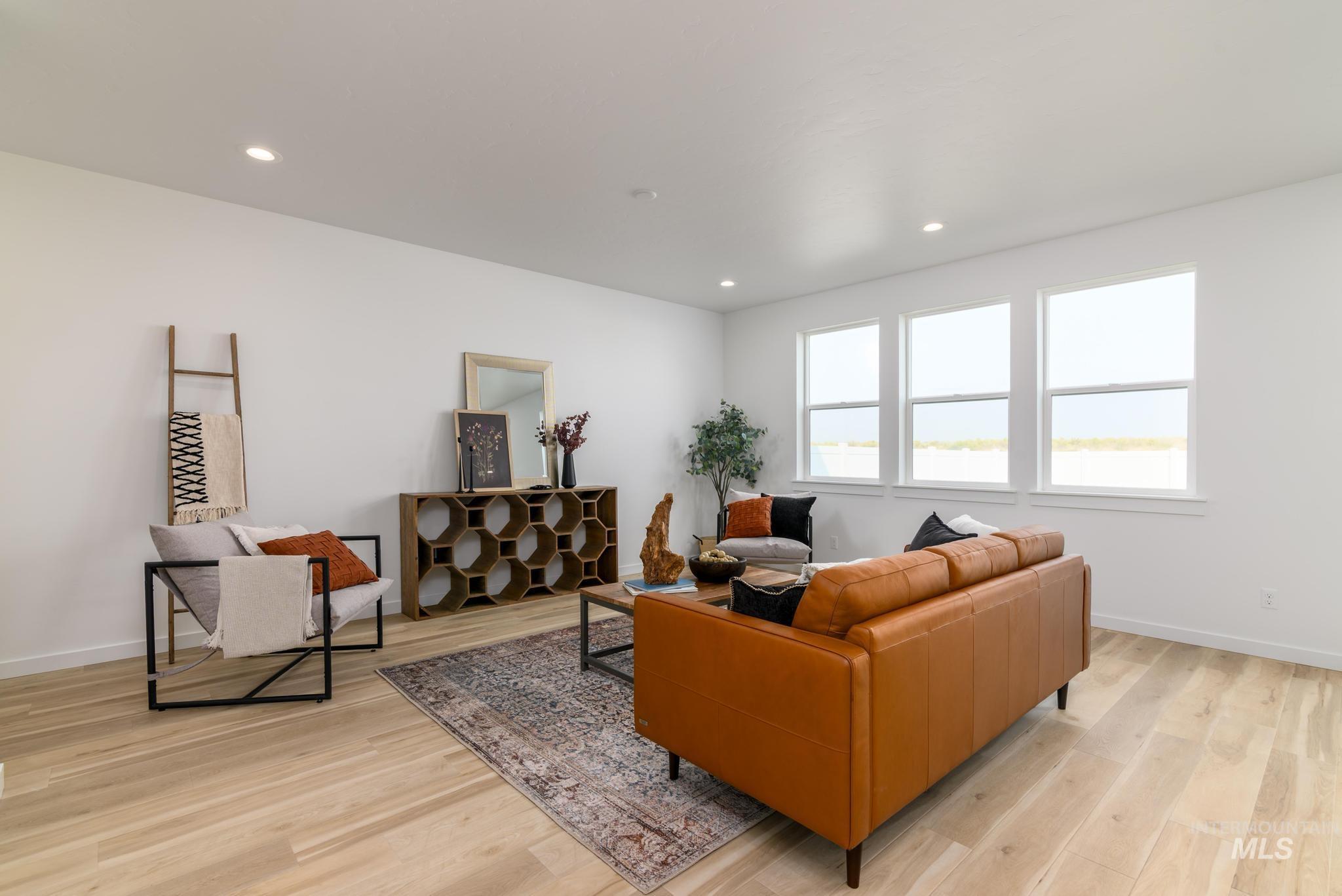 Living area with light wood-style floors and recessed lighting