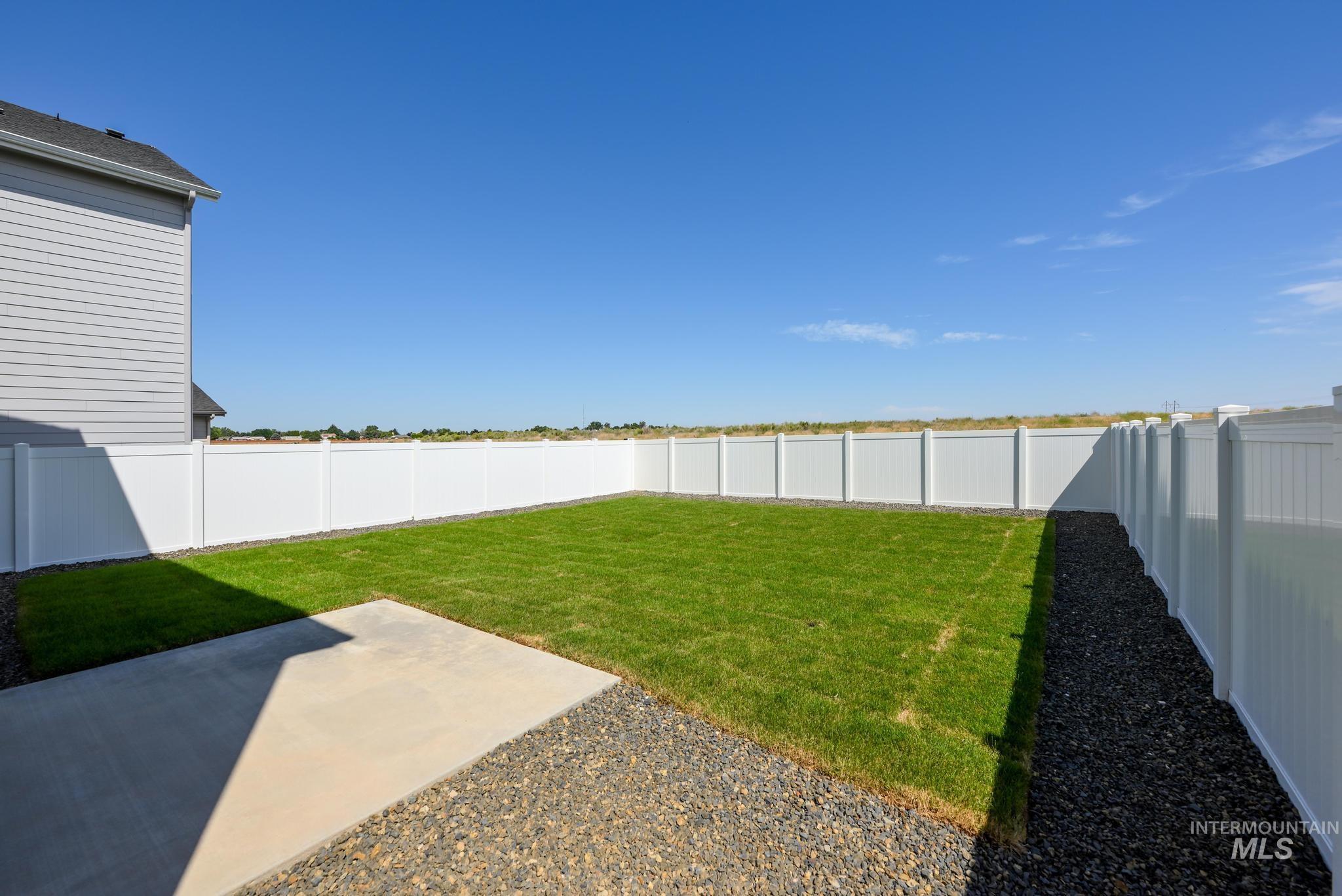 Fenced backyard featuring a patio