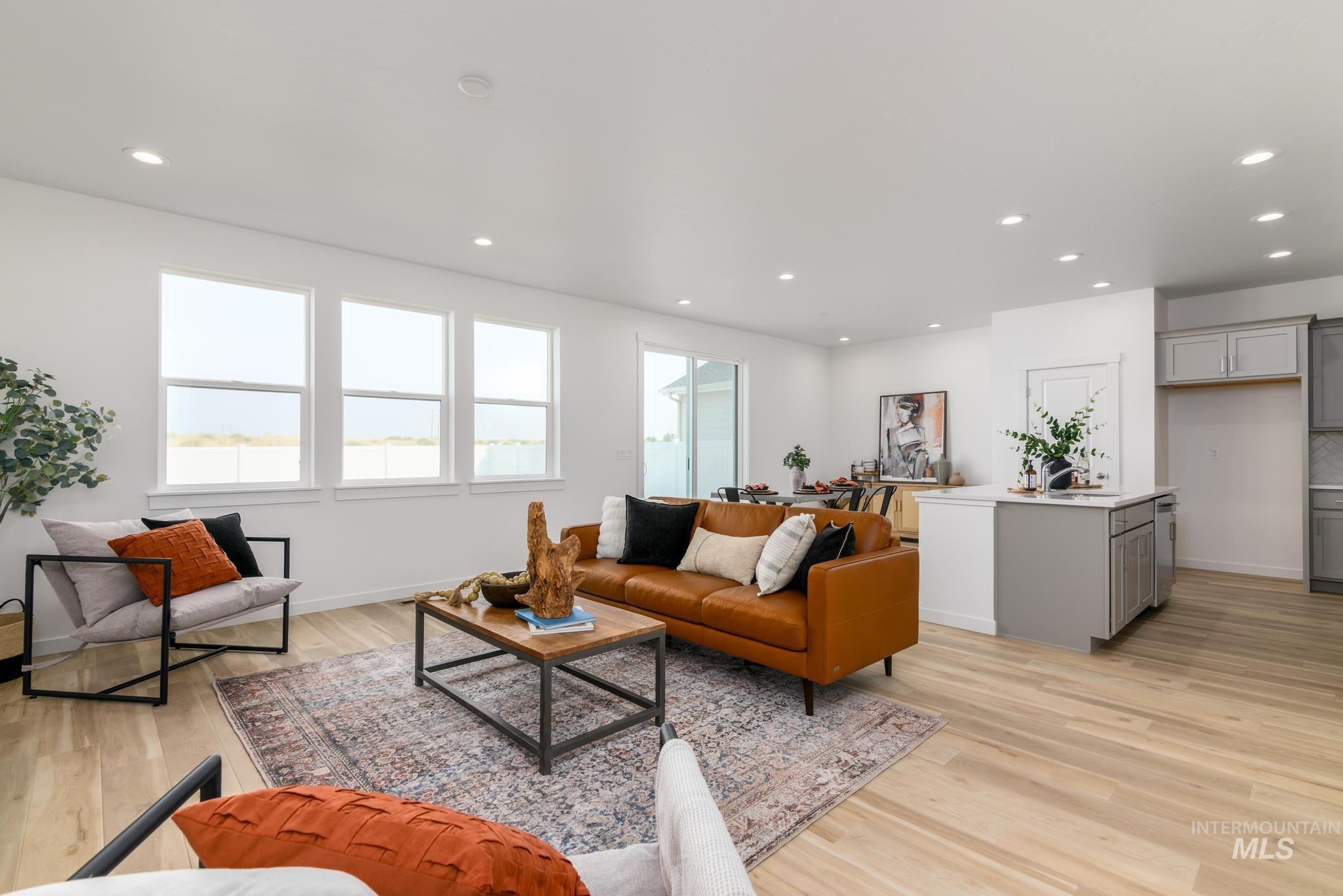 Living area with recessed lighting and light wood-type flooring