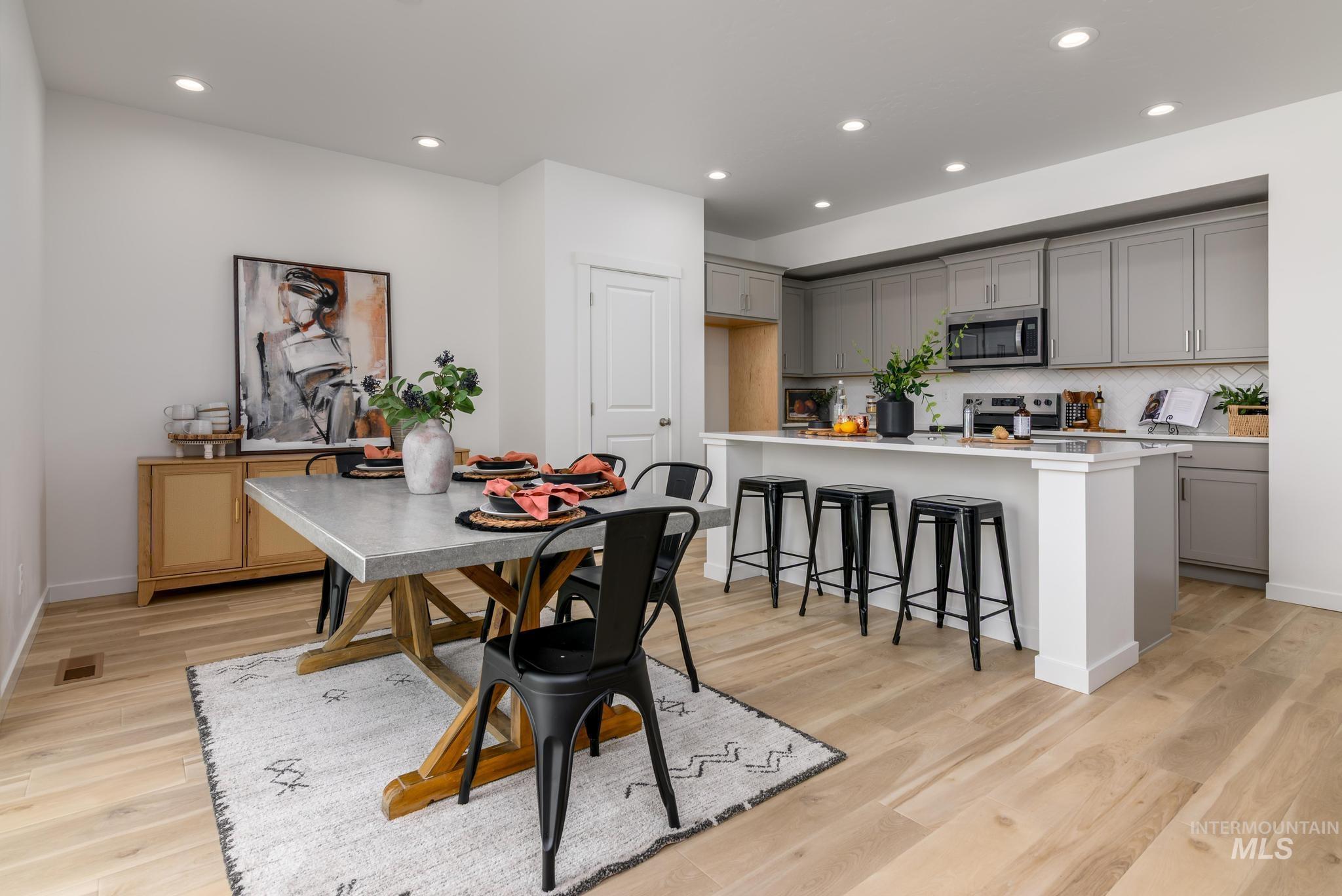 Dining room with recessed lighting and light wood finished floors
