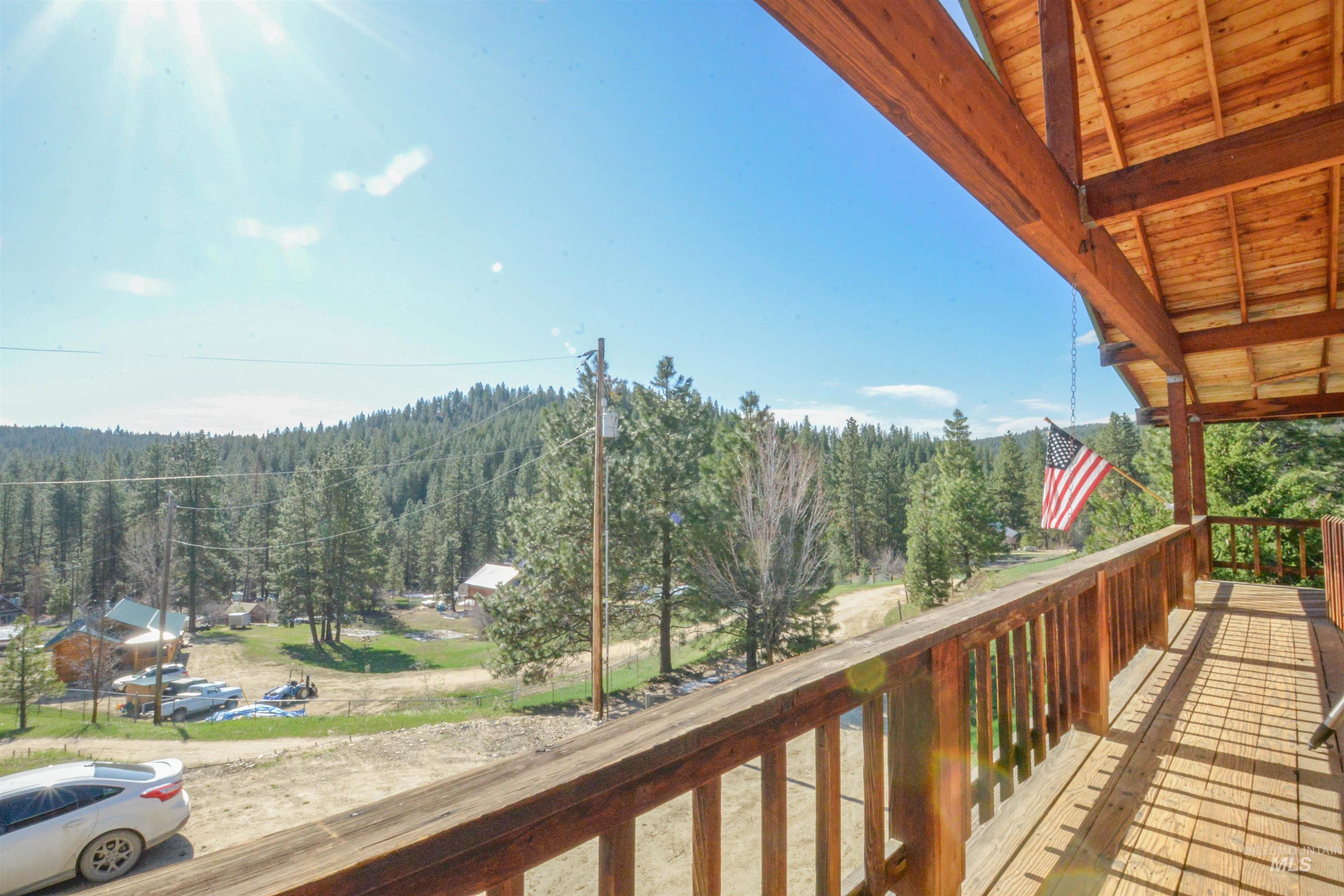 Balcony featuring a wooded view