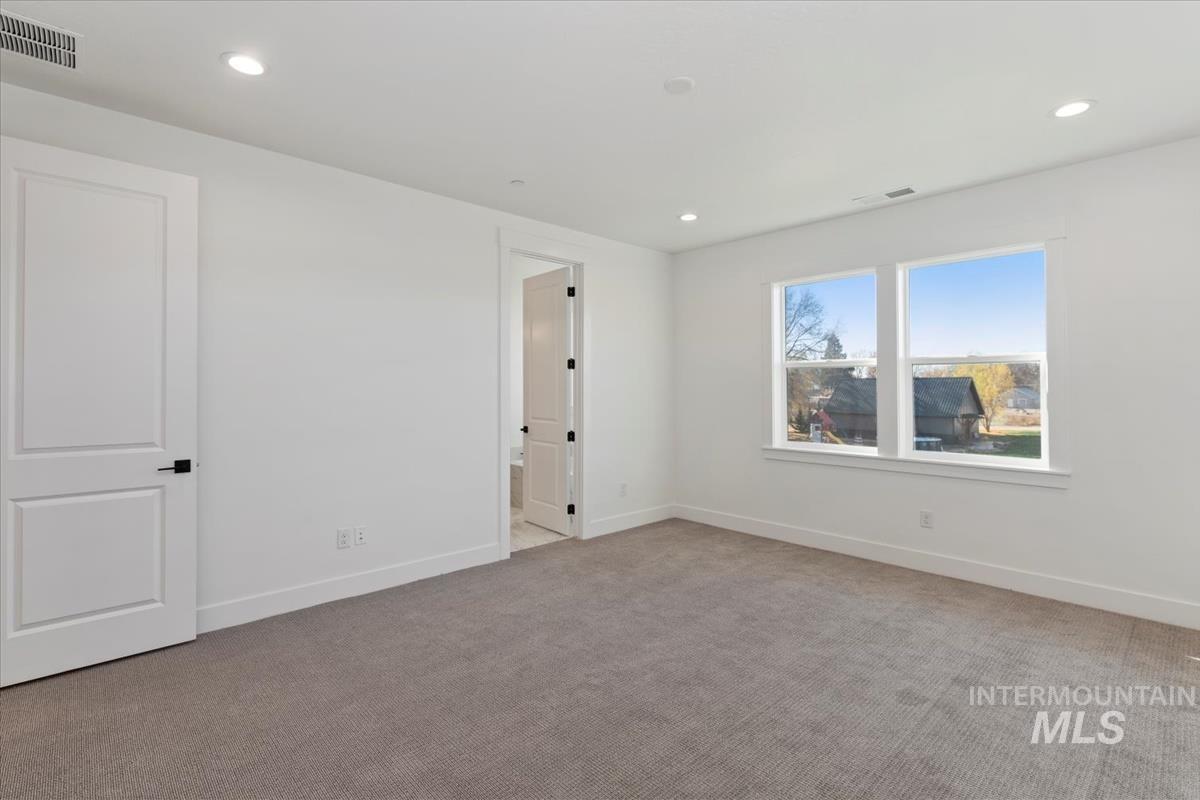 Spare room with light colored carpet and recessed lighting