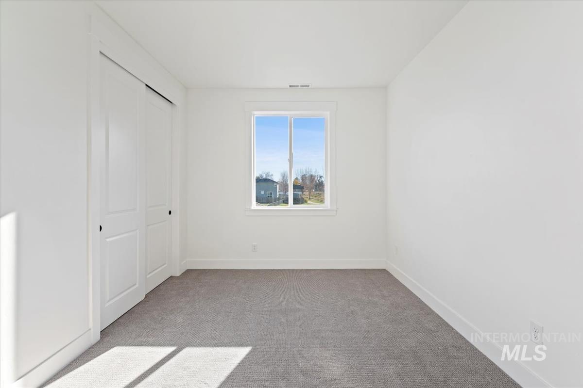 Unfurnished bedroom featuring carpet floors and a closet