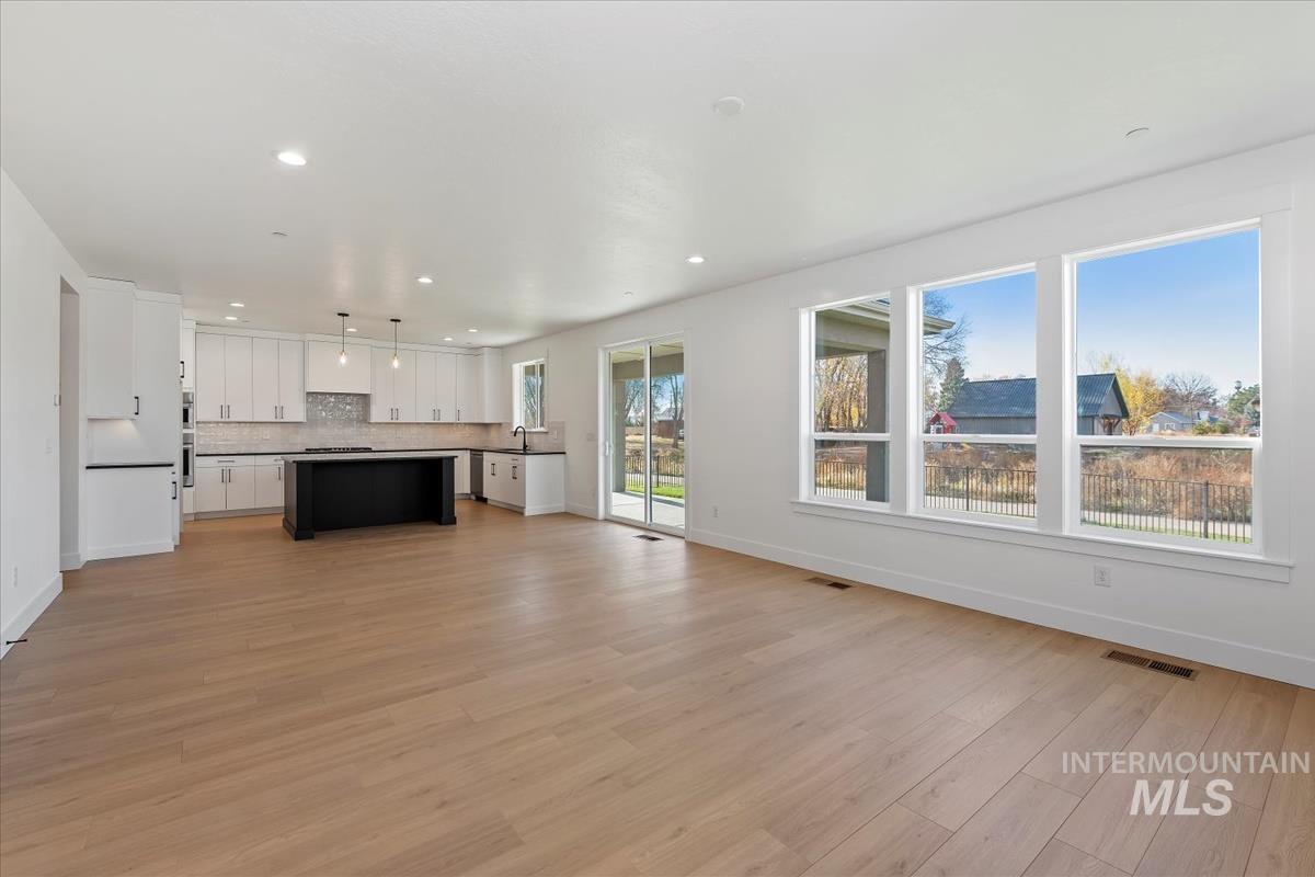 Unfurnished living room with light wood-style flooring and recessed lighting