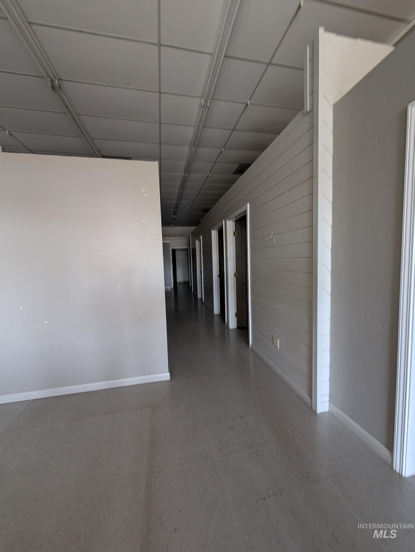 Empty room featuring baseboards