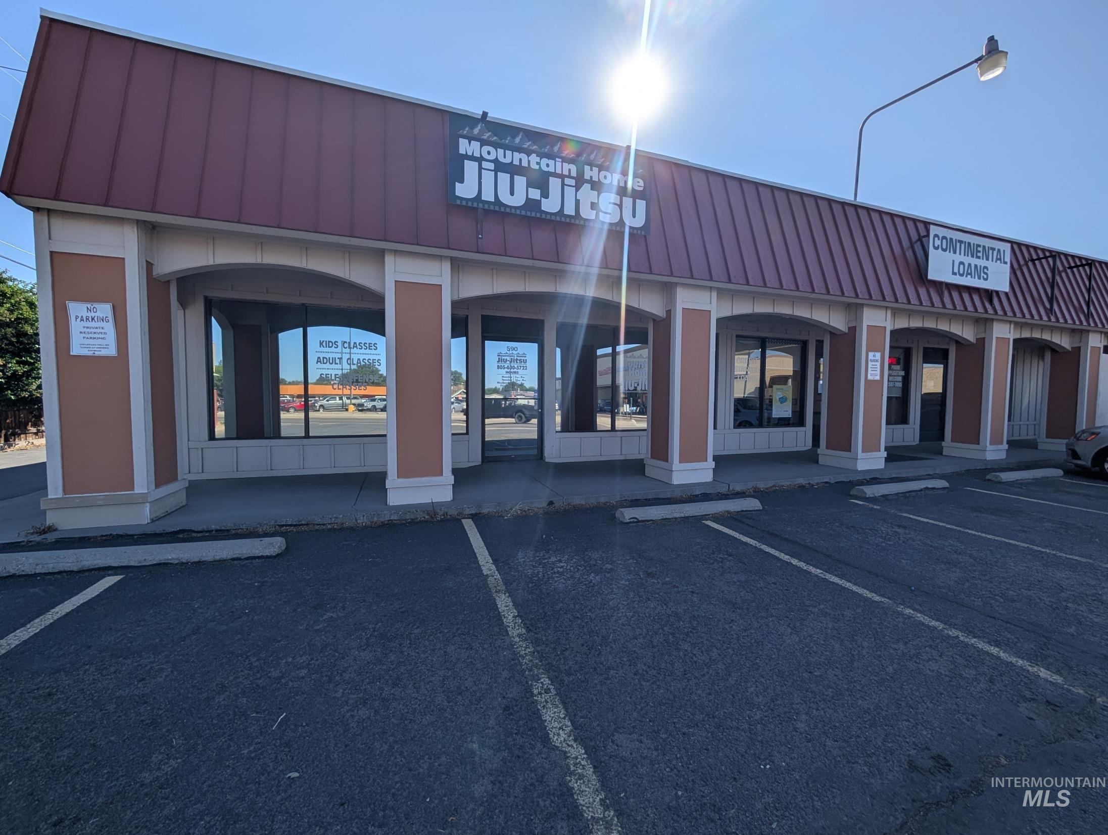 View of commercial property with uncovered parking
