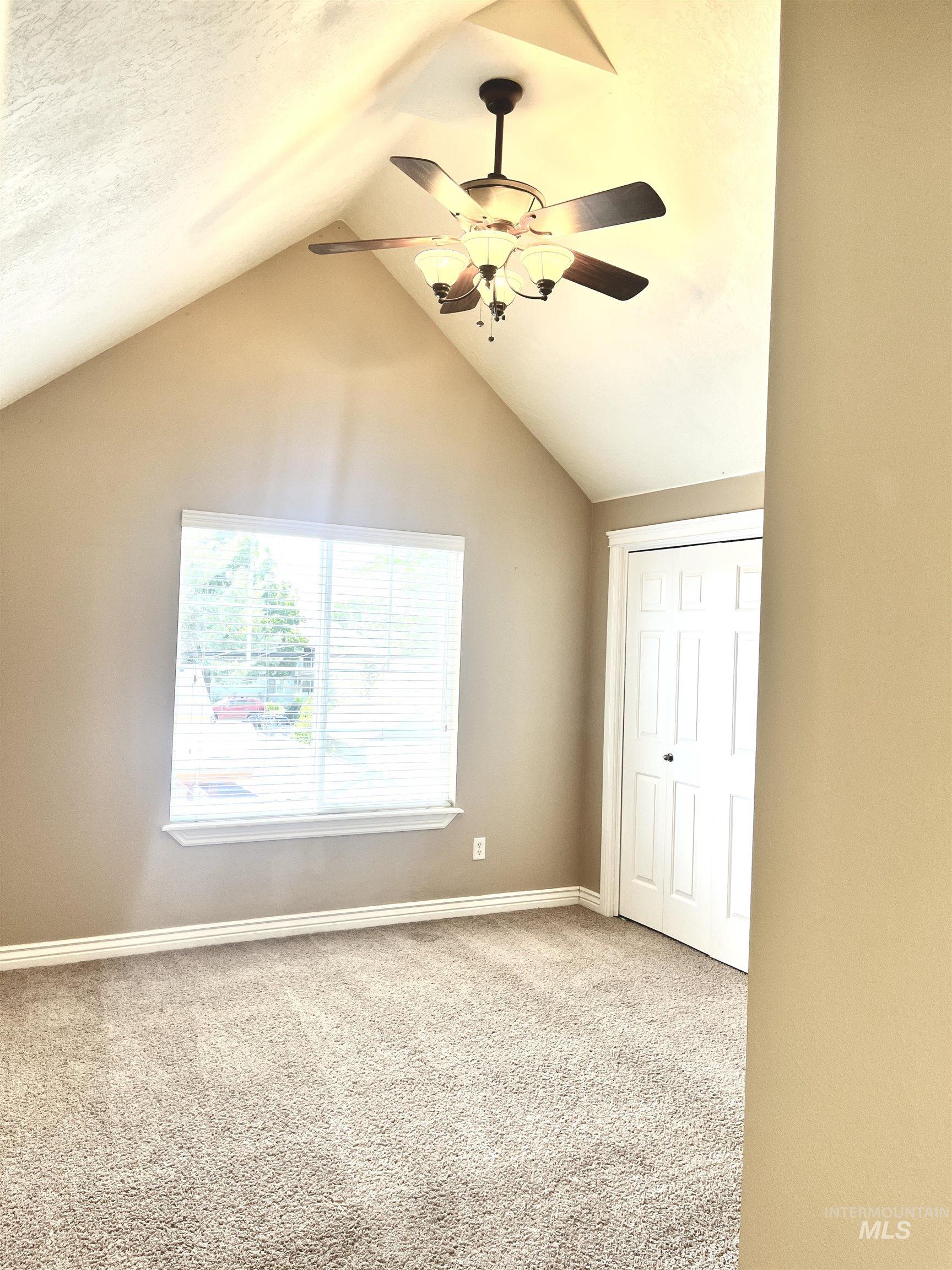 Upstairs bedroom.  Vaulted Ceilings.  Dual closets.  Ceiling fan.  Large window.